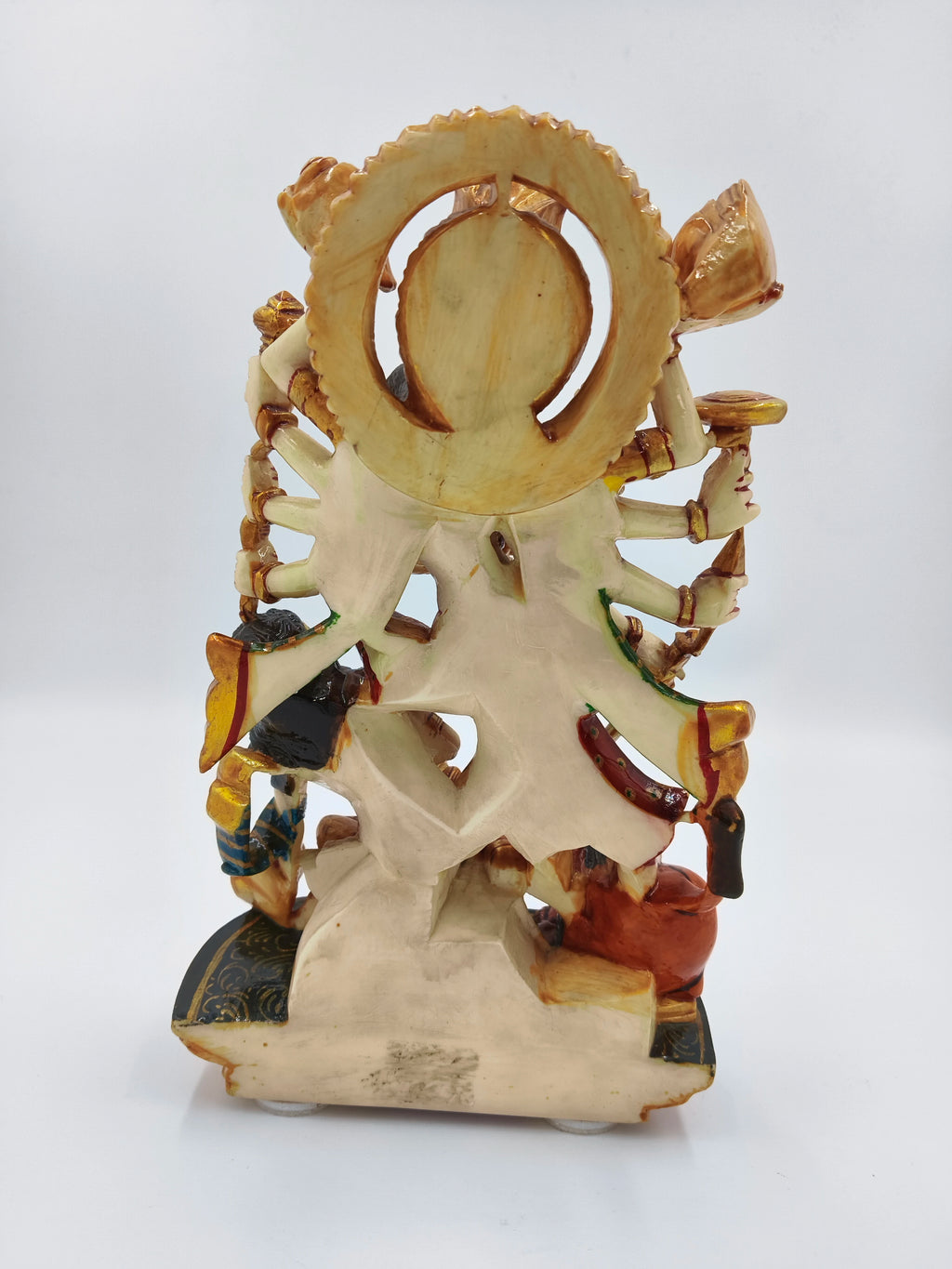 Back view of polyresin sculpture of Hindu goddess Durga with multiple arms and detailed base