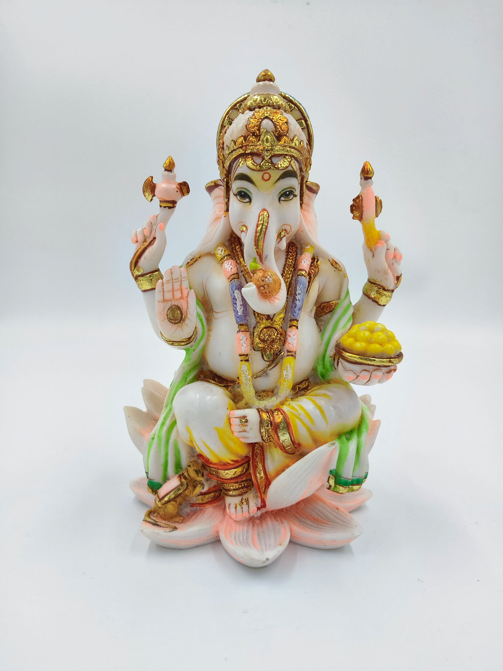 Polyresin statue of deity Ganesh seated on a lotus flower with four arms