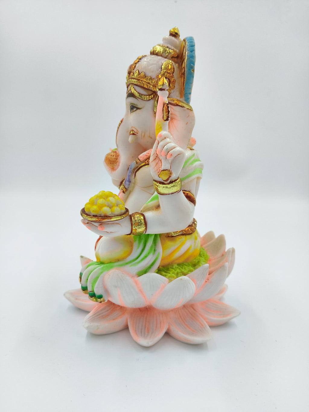 Polyresin sculpture of Ganesh seated on a pink lotus flower, side view