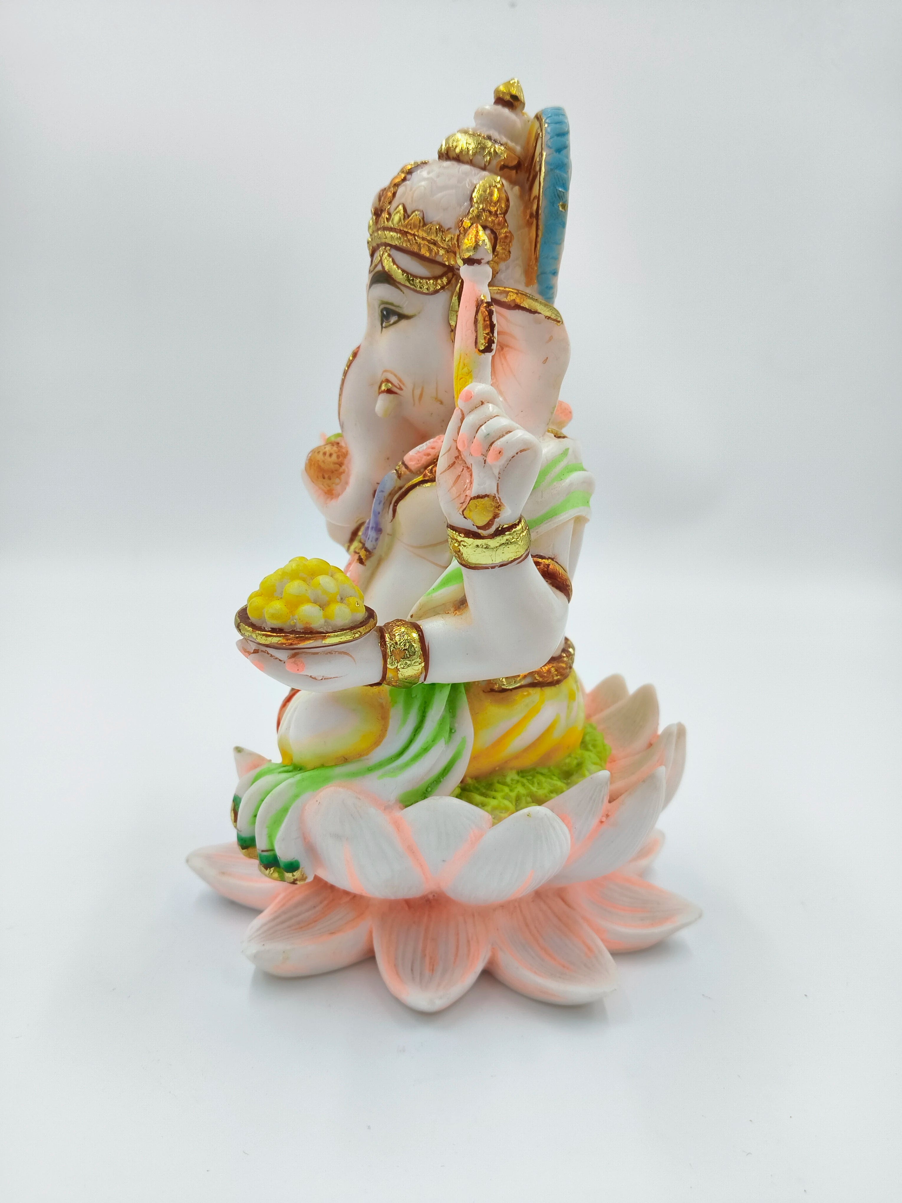 Polyresin sculpture of Ganesh seated on a pink lotus flower, side view