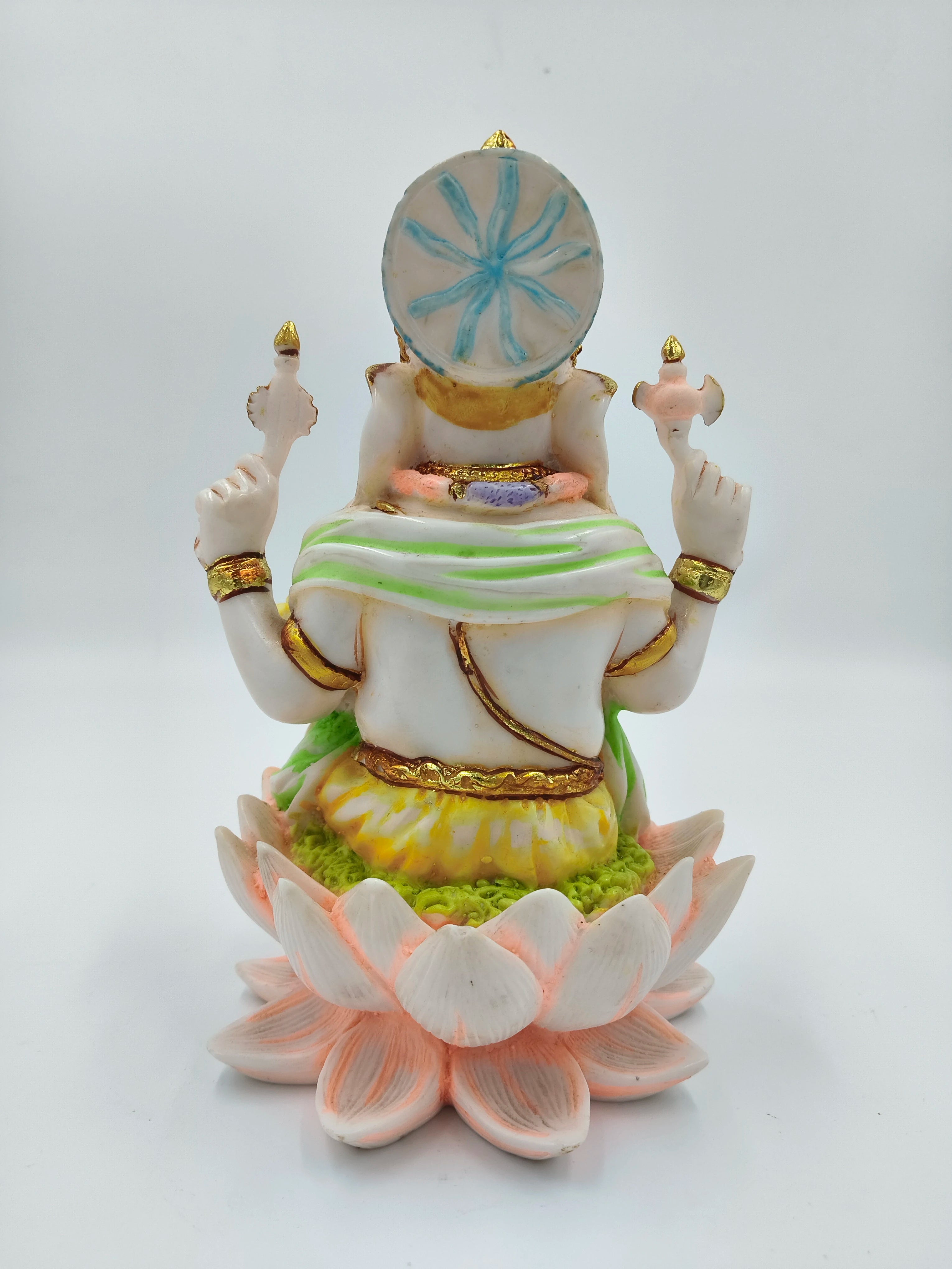 Back view of polyresin Ganesh statue seated on a lotus base with decorative colors