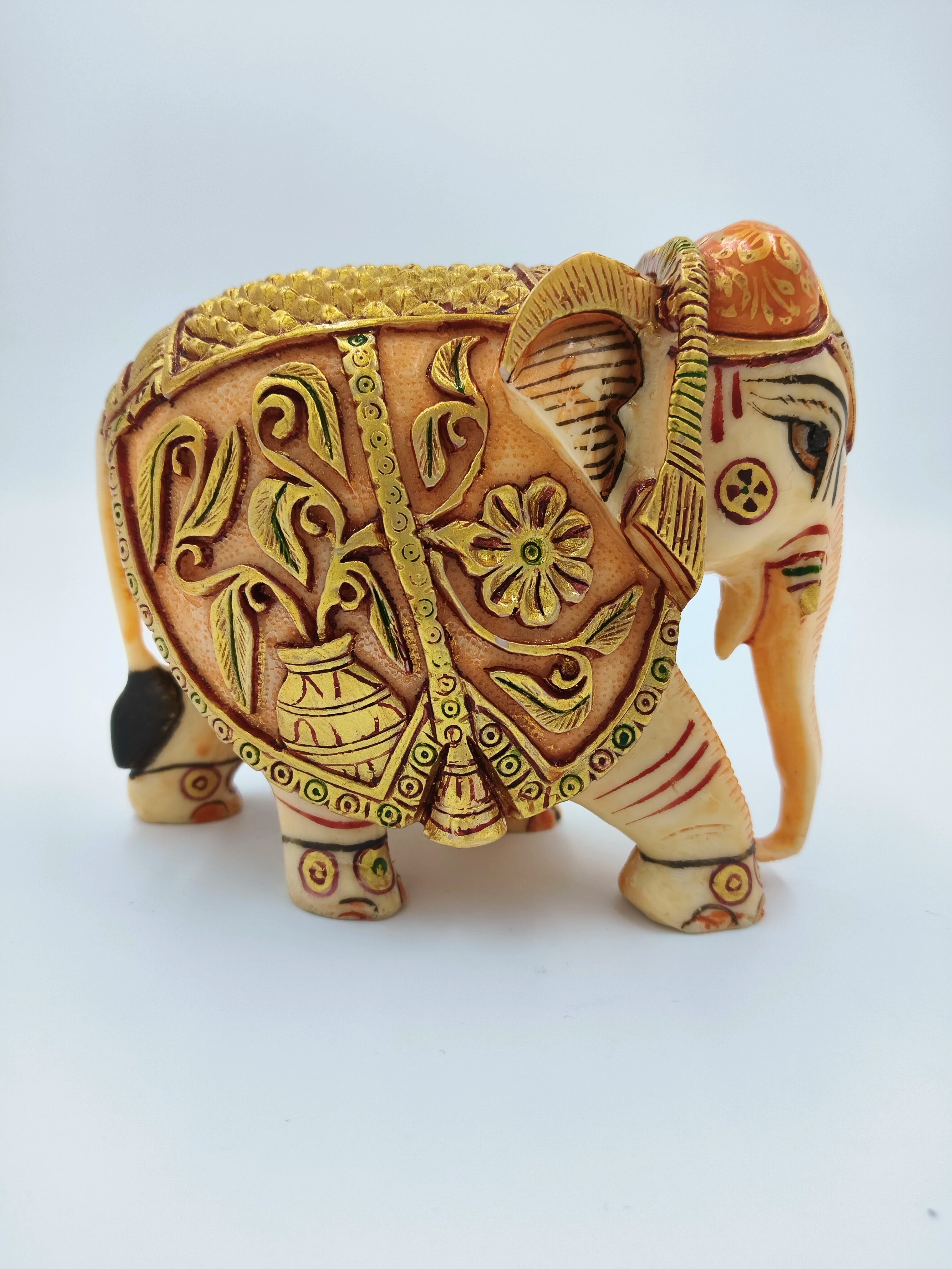 Side view of polyresin elephant figurine with floral and decorative patterns