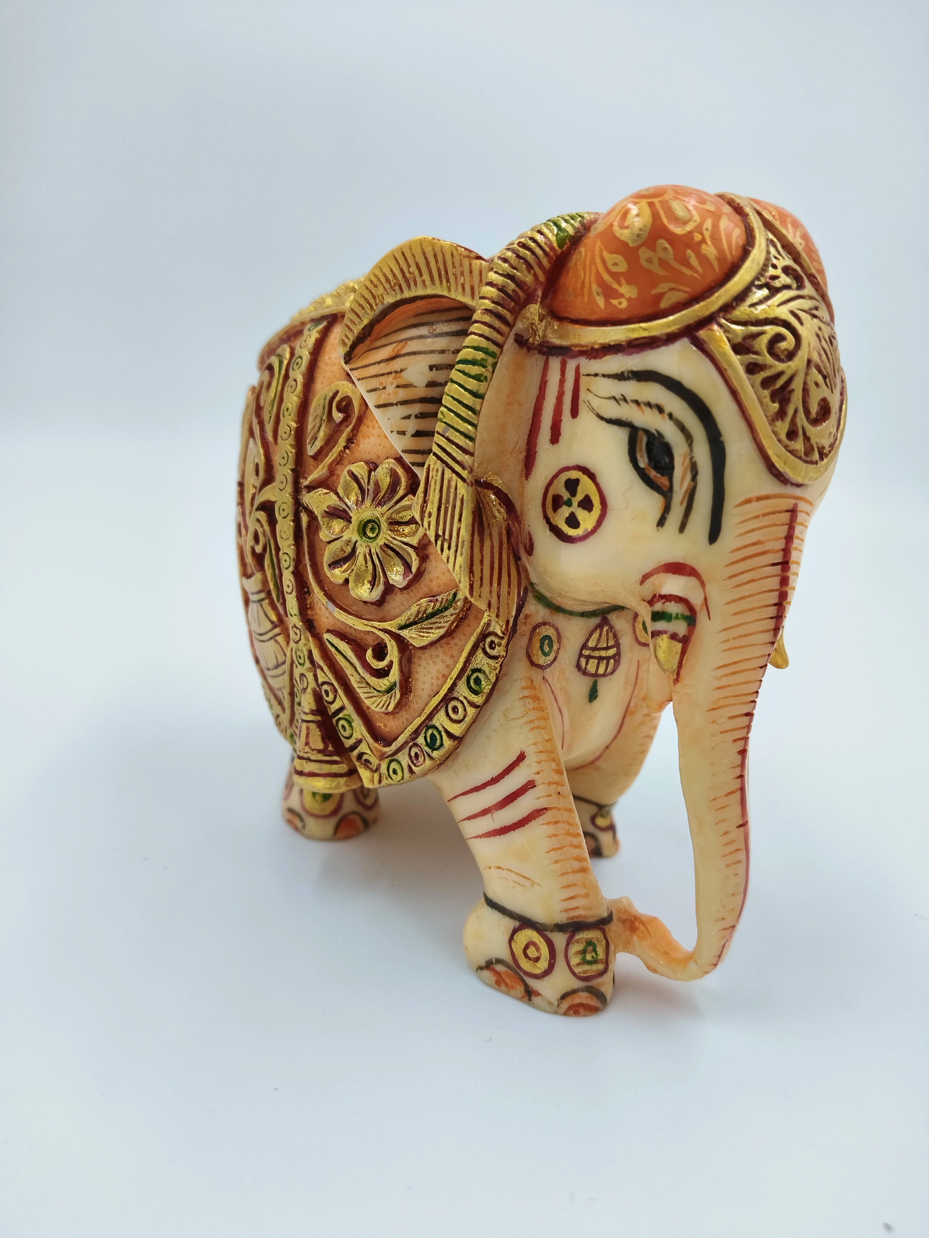 Small polyresin elephant figurine with intricate painted decorations and golden accents