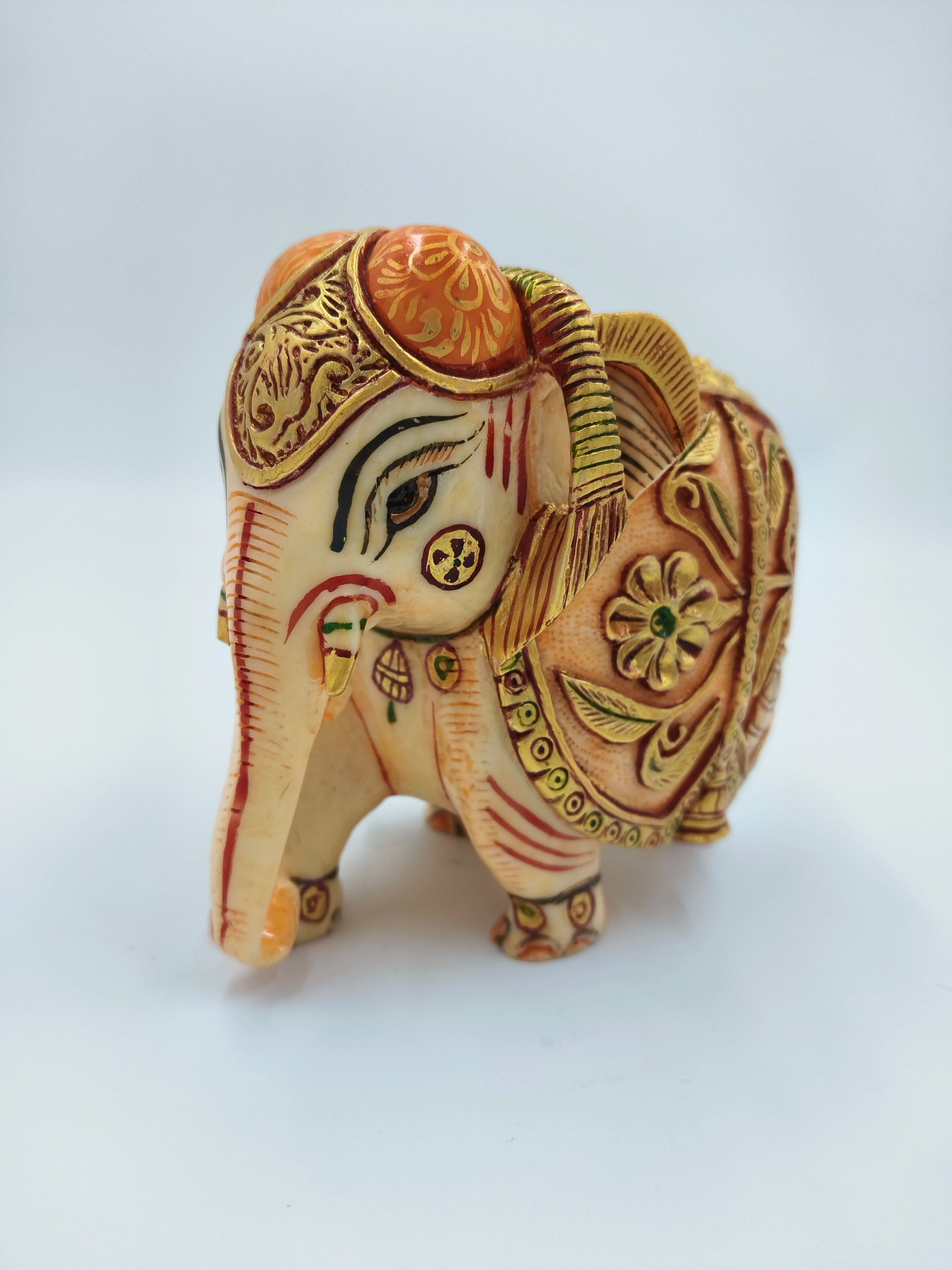 small polyresin elephant figurine with intricate painted patterns and decorations