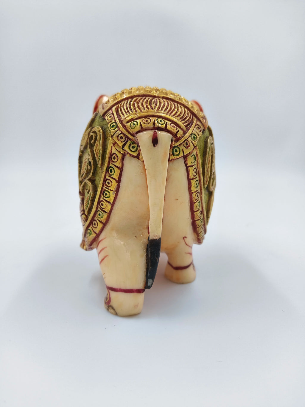 Back view of small polyresin elephant figurine with decorative detailing