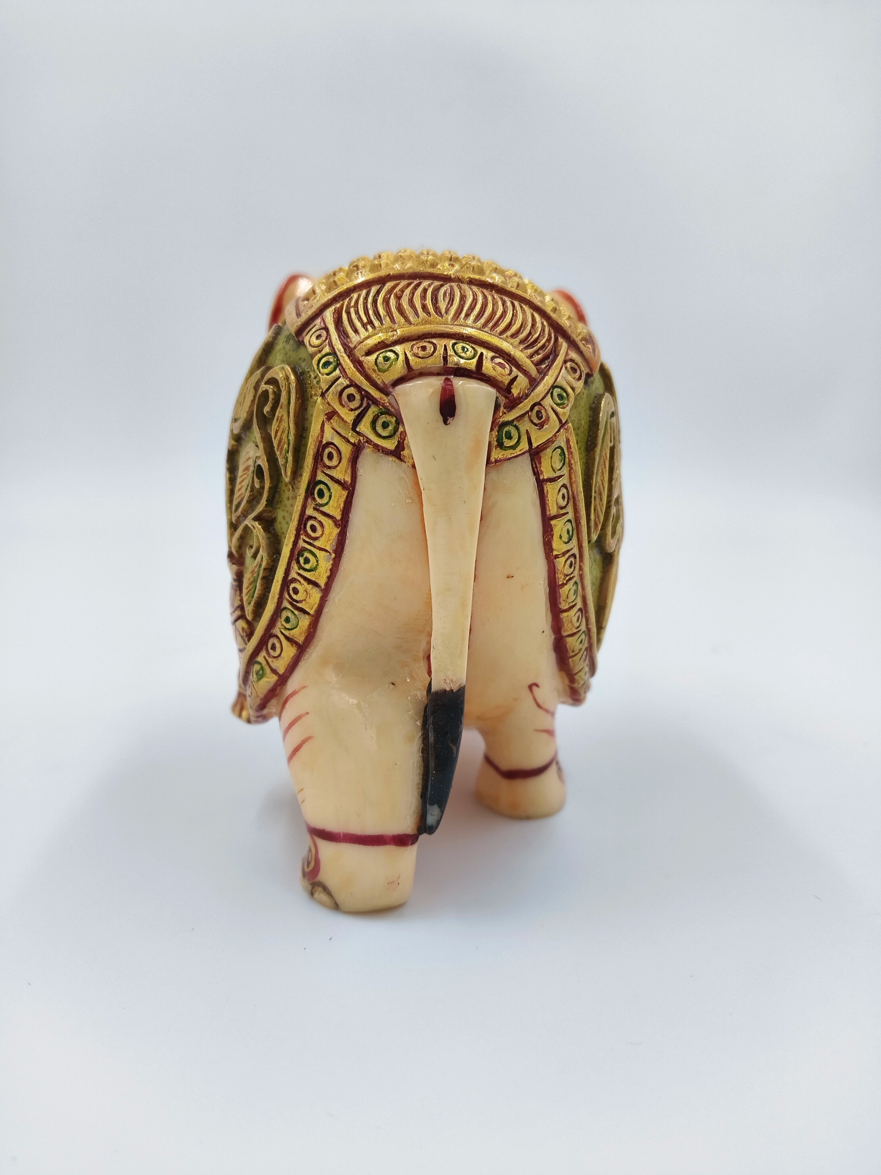 Back view of small polyresin elephant figurine with decorative detailing