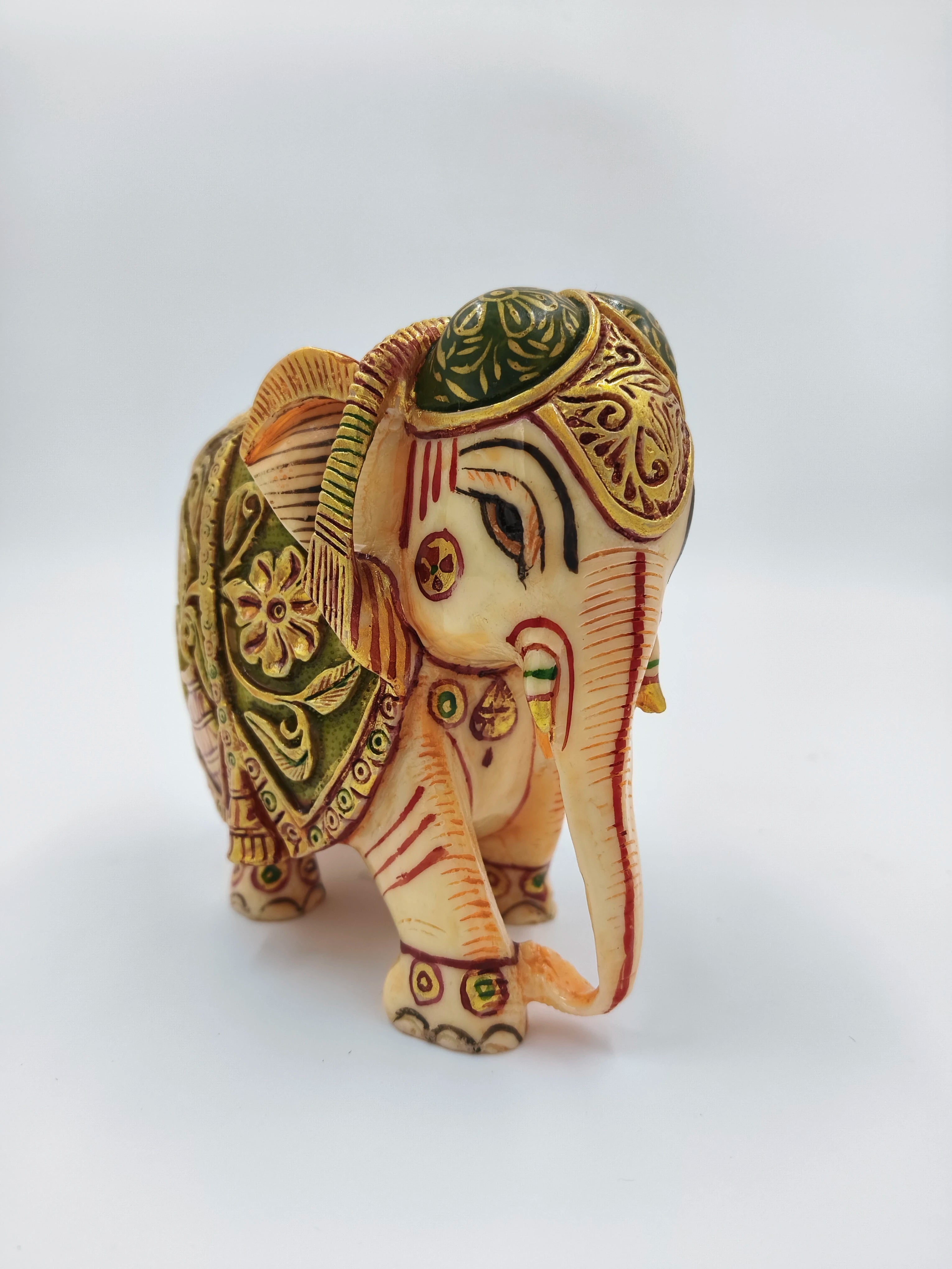Small polyresin elephant figurine with detailed hand-painted decorations front view