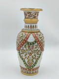 Large marble flower vase with intricate floral and leaf patterns in gold, red, and green