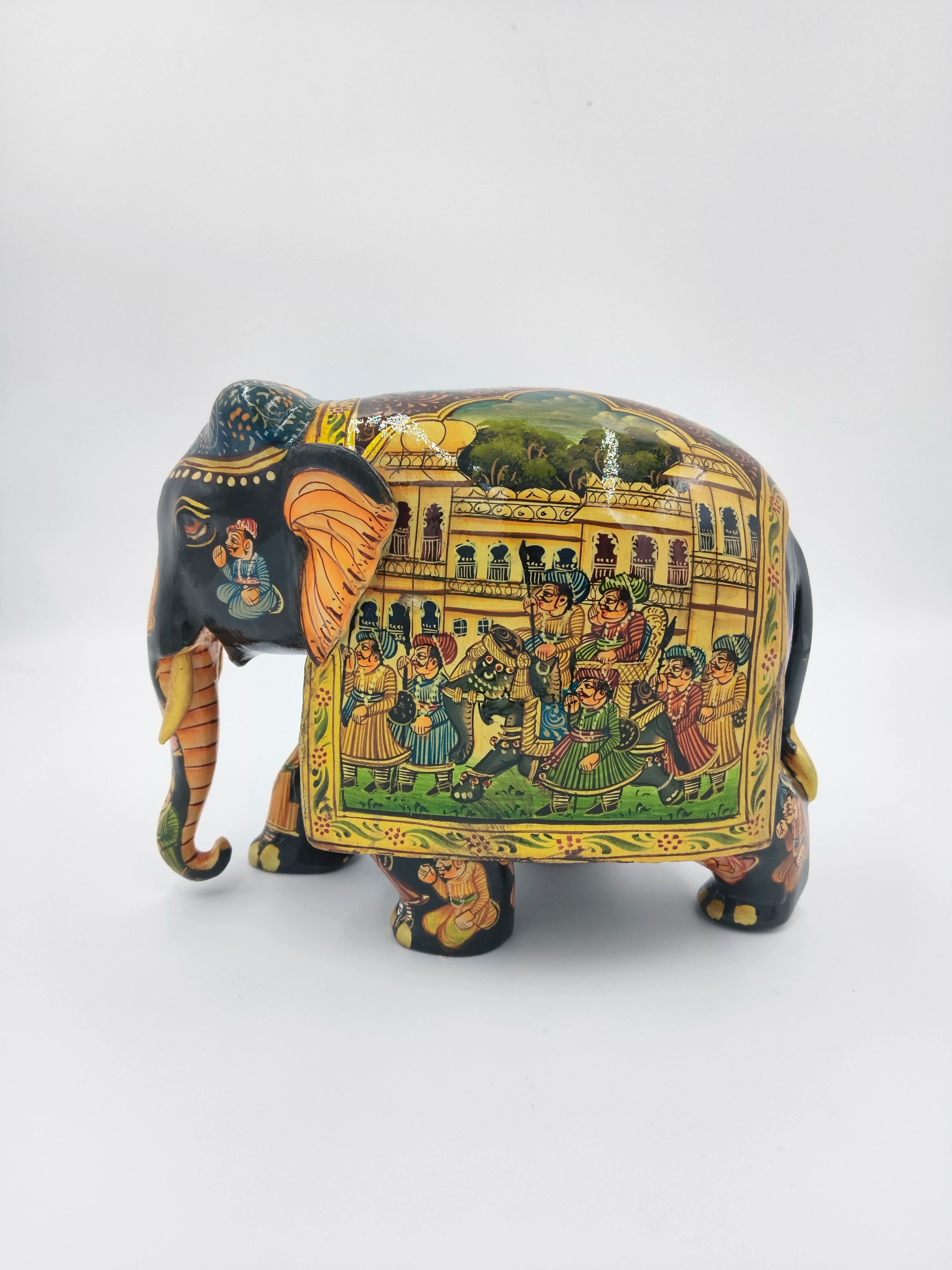 Hand-painted wooden elephant figurine with detailed procession artwork on side