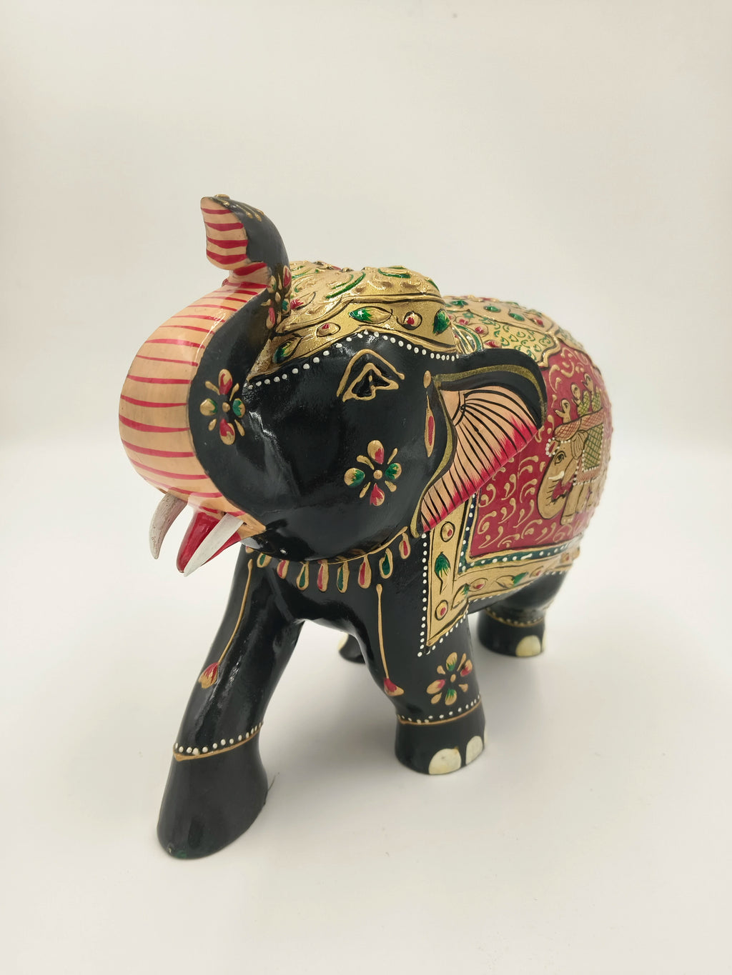 Hand-painted wooden elephant sculpture with embossed floral and elephant designs