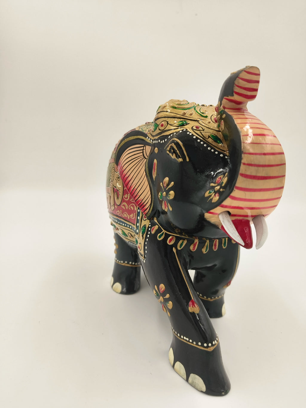 Hand-painted wooden elephant sculpture with embossed floral and decorative patterns