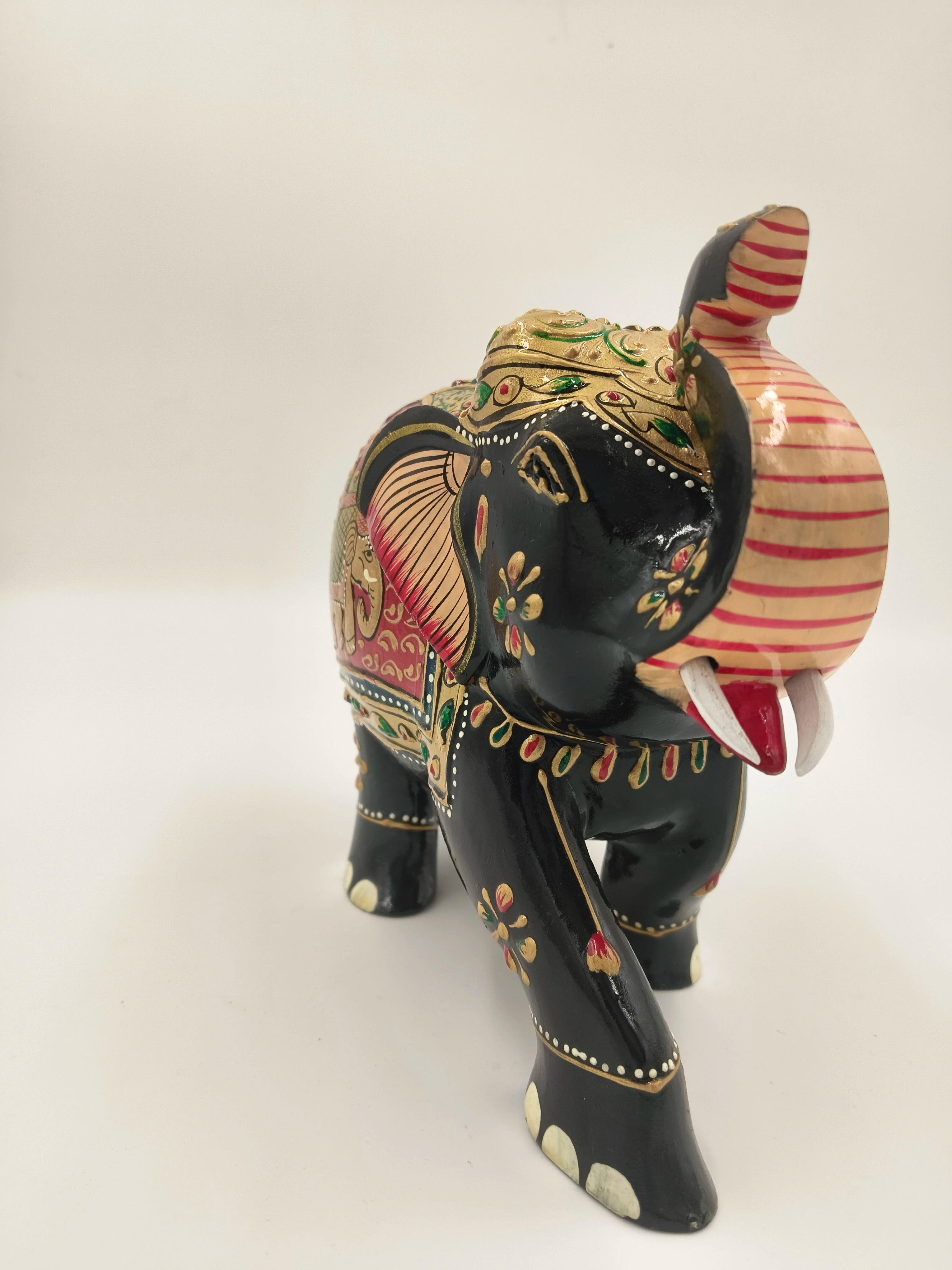 Hand-painted wooden elephant sculpture with embossed floral and decorative patterns
