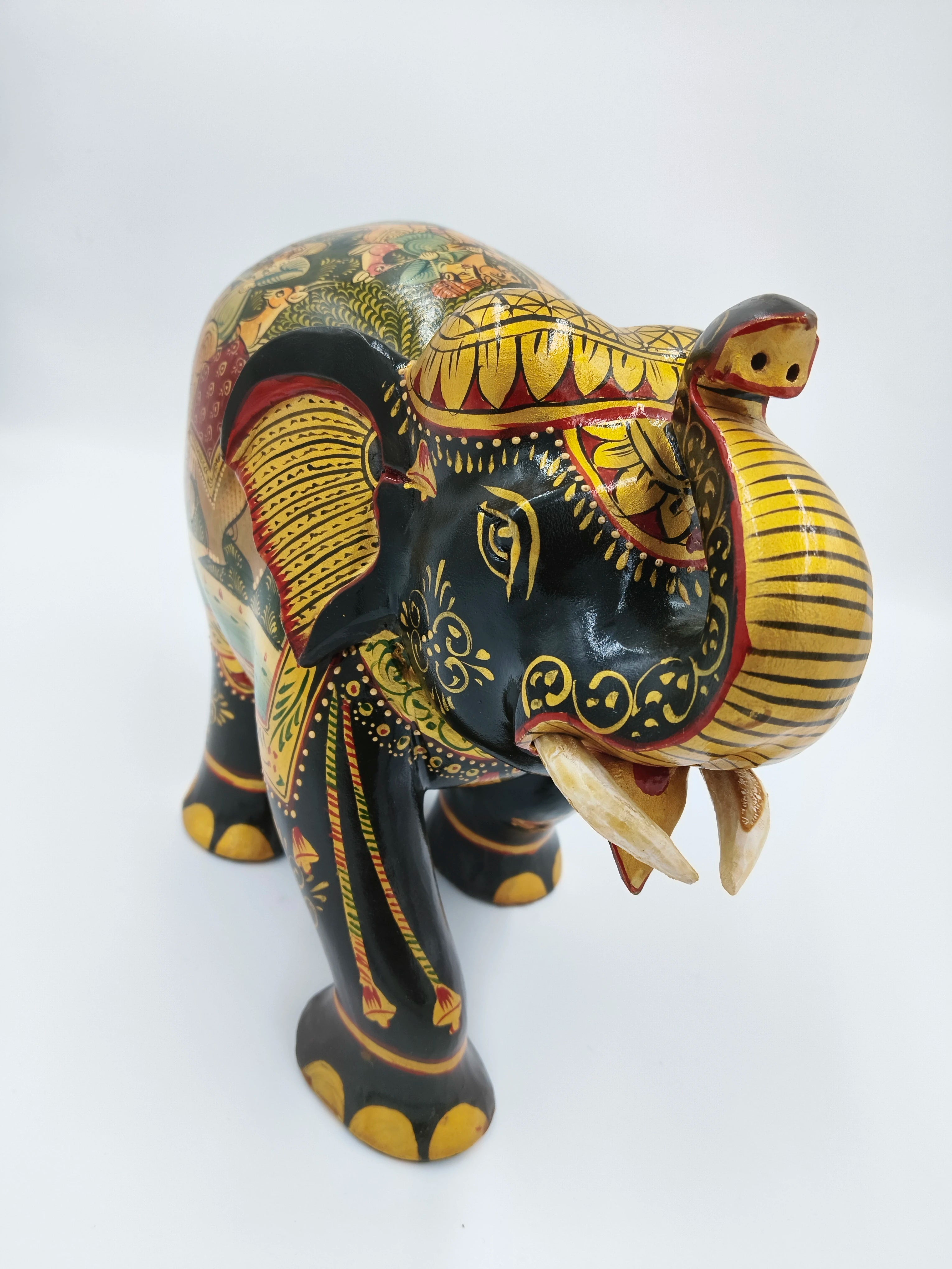 Hand-painted wooden elephant miniature sculpture with detailed yellow and red patterns