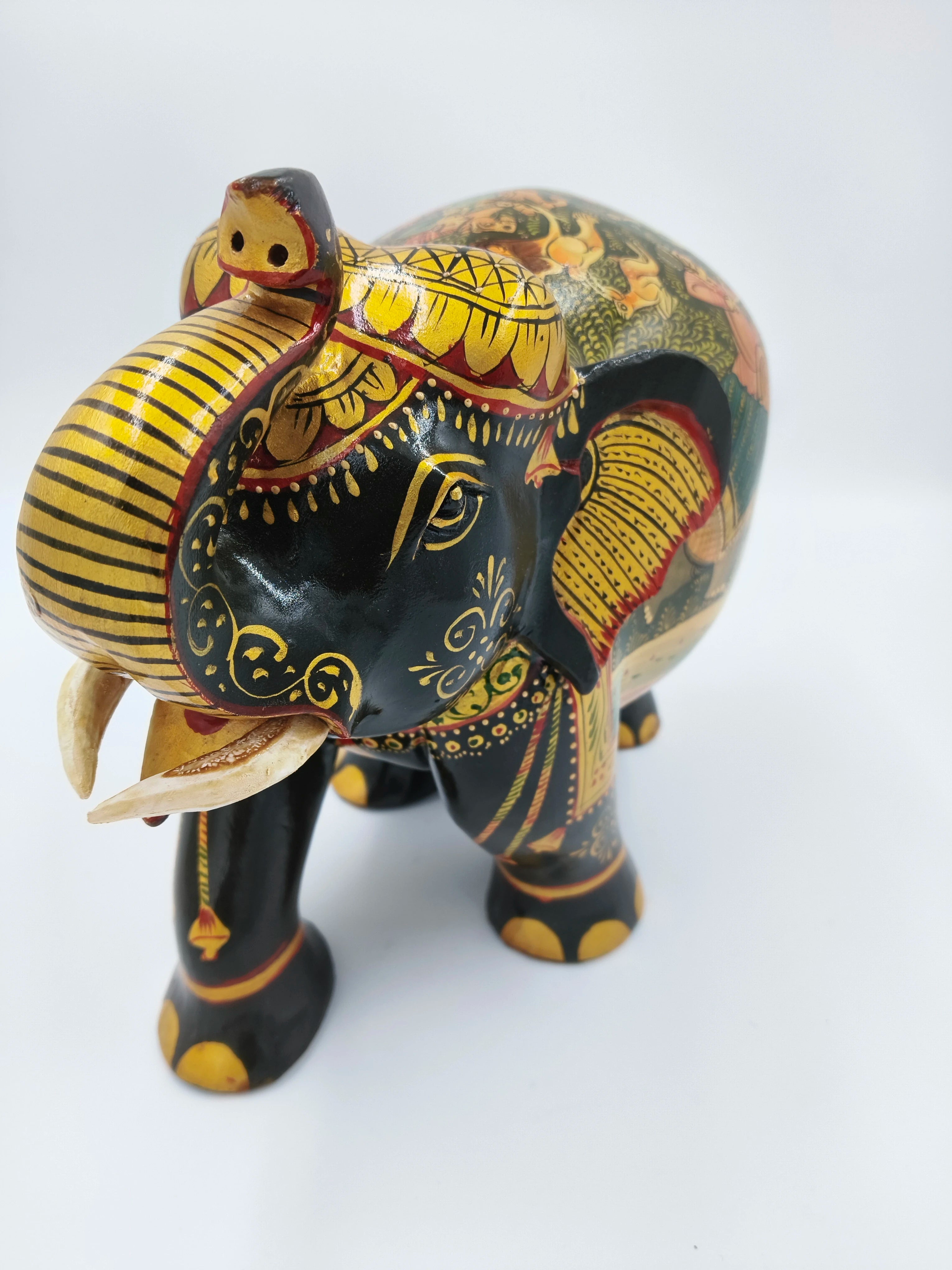 Large wood elephant figurine painted black with intricate yellow and red designs