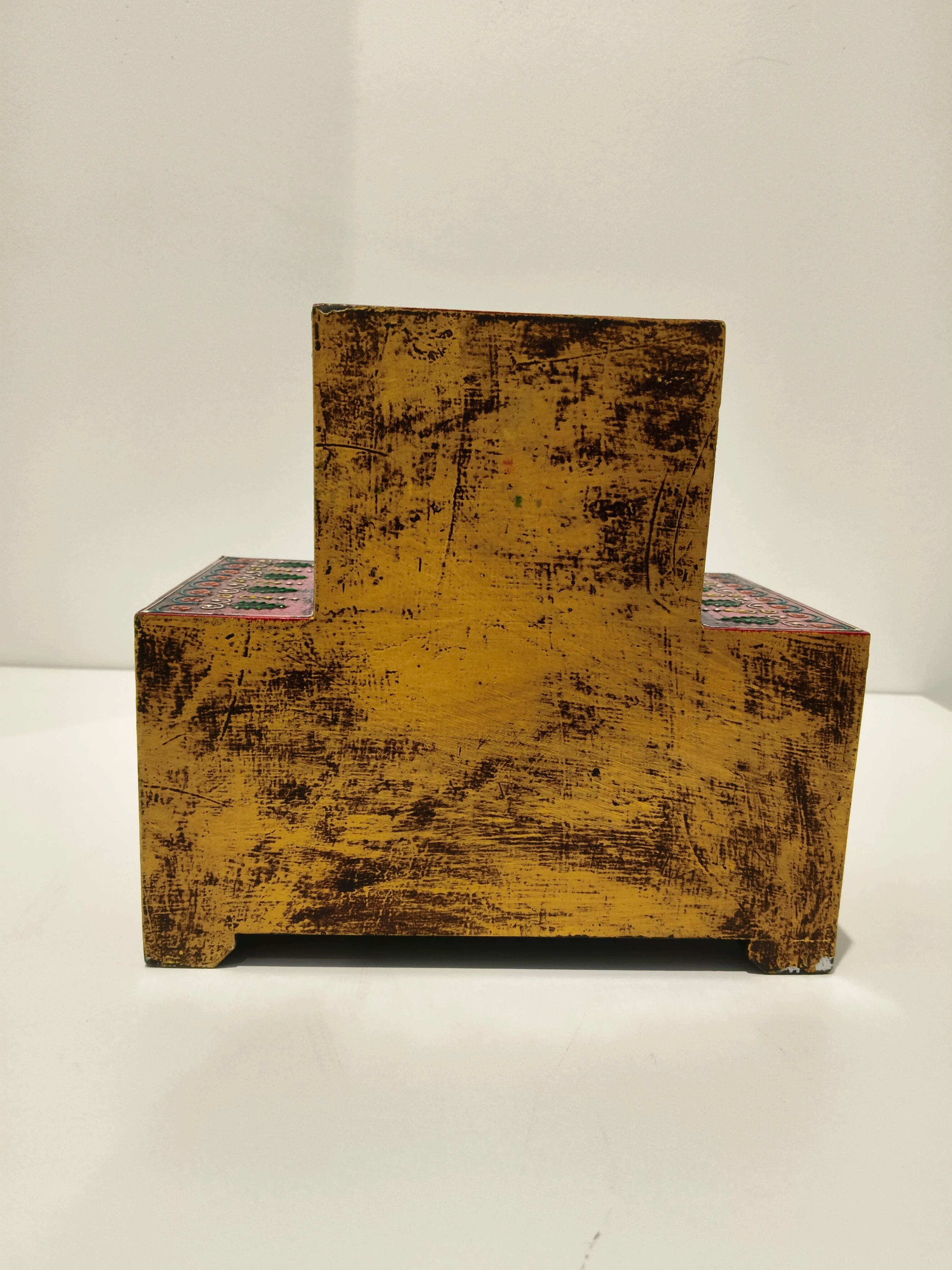 Back view of a large wooden spice box with a distressed yellow finish