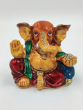 Front view of brass enamel Ganesh statue decorated with artificial stones