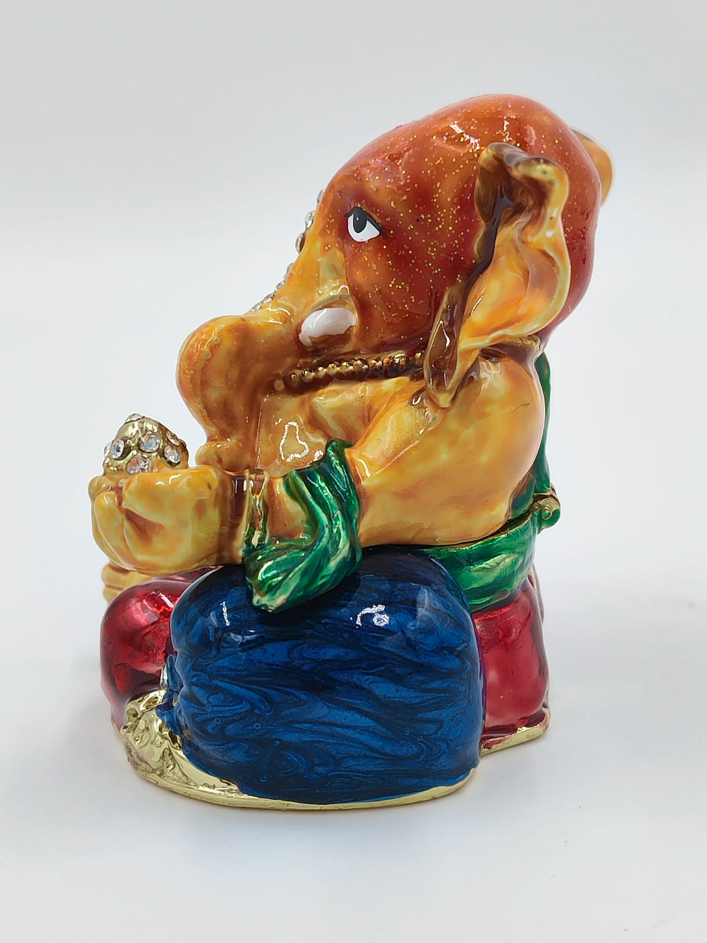 Side view of a colorful brass enamel Ganesh statue with artificial stones