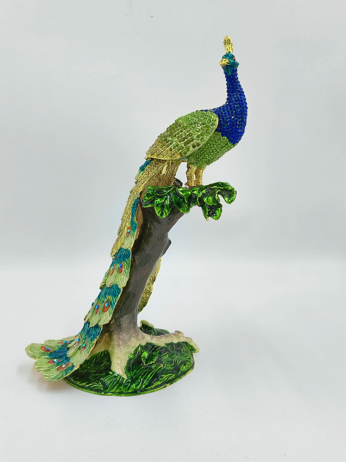 Large brass enamel peacock figurine with stone accents on tree branch base