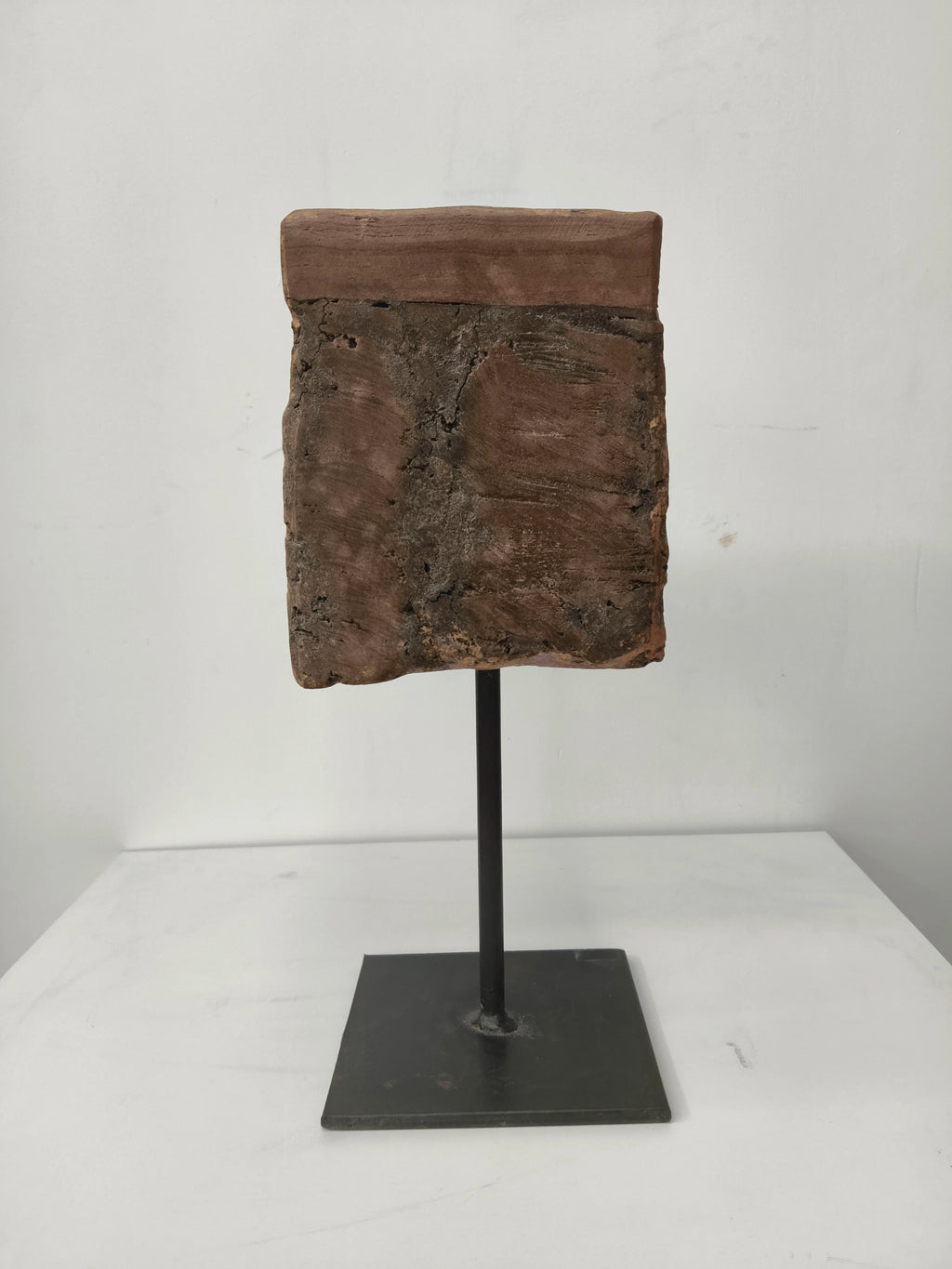 Large wooden candle stand with natural texture on metal pedestal base