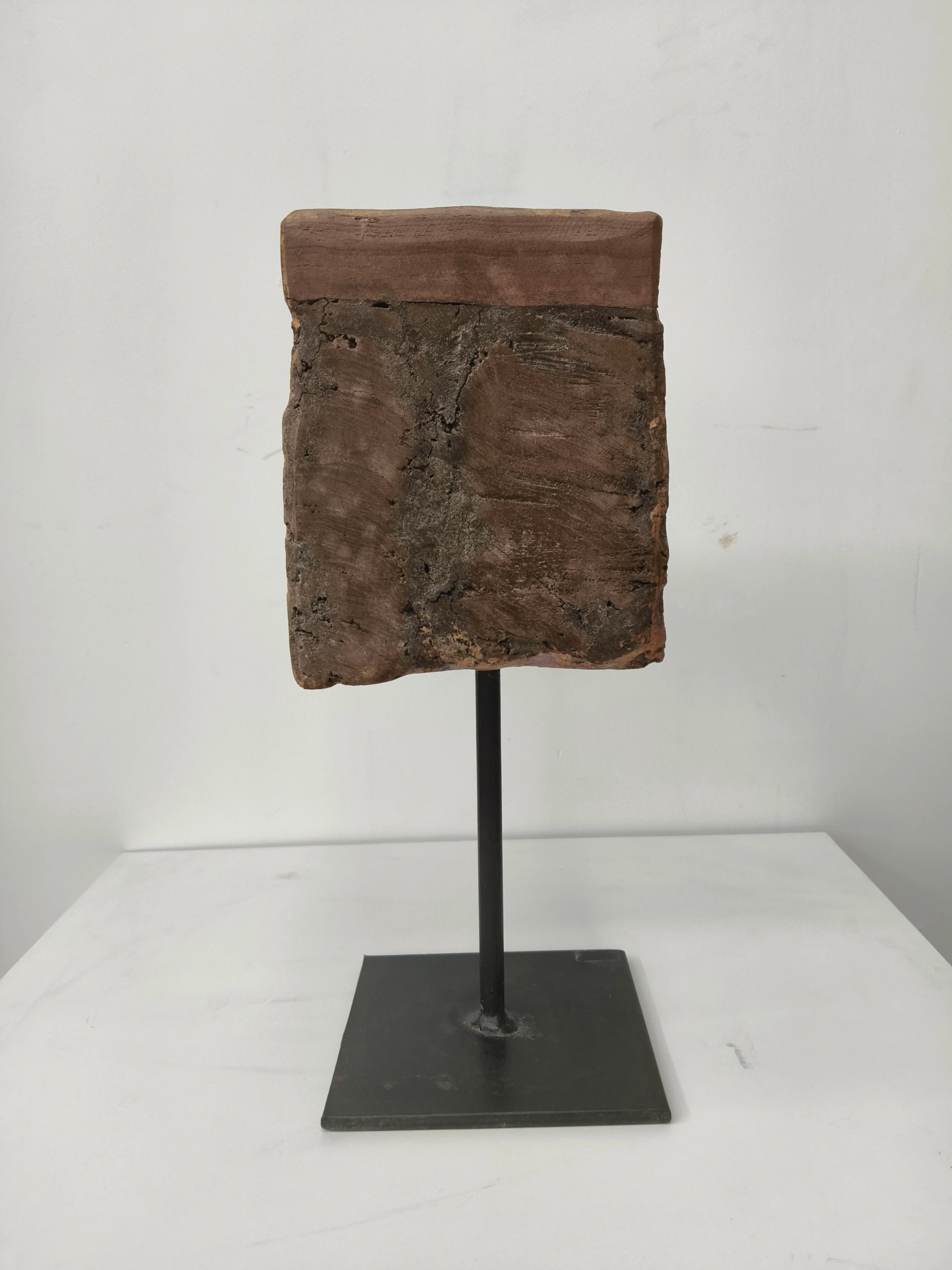 Large wooden candle stand with natural texture on metal pedestal base