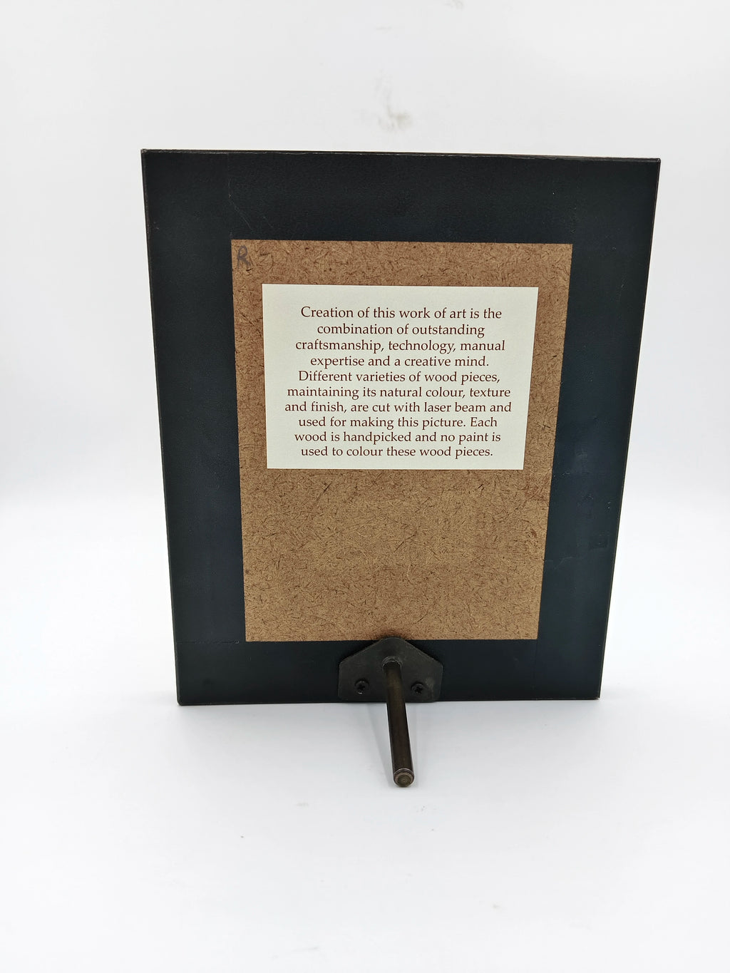 Back view of mini wooden photo frame with informational label and metal stand