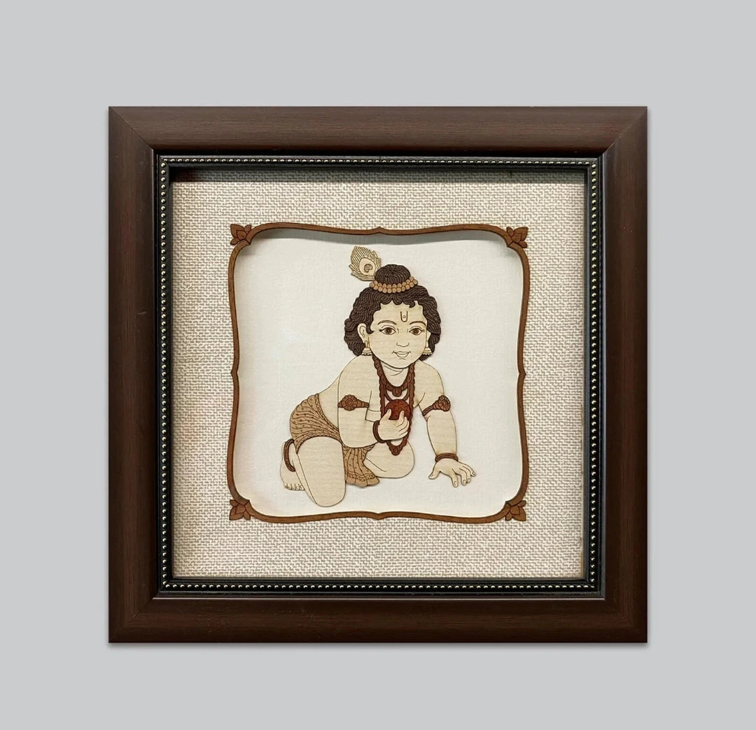 Wooden framed art picture of baby Krishna crawling with a peacock feather