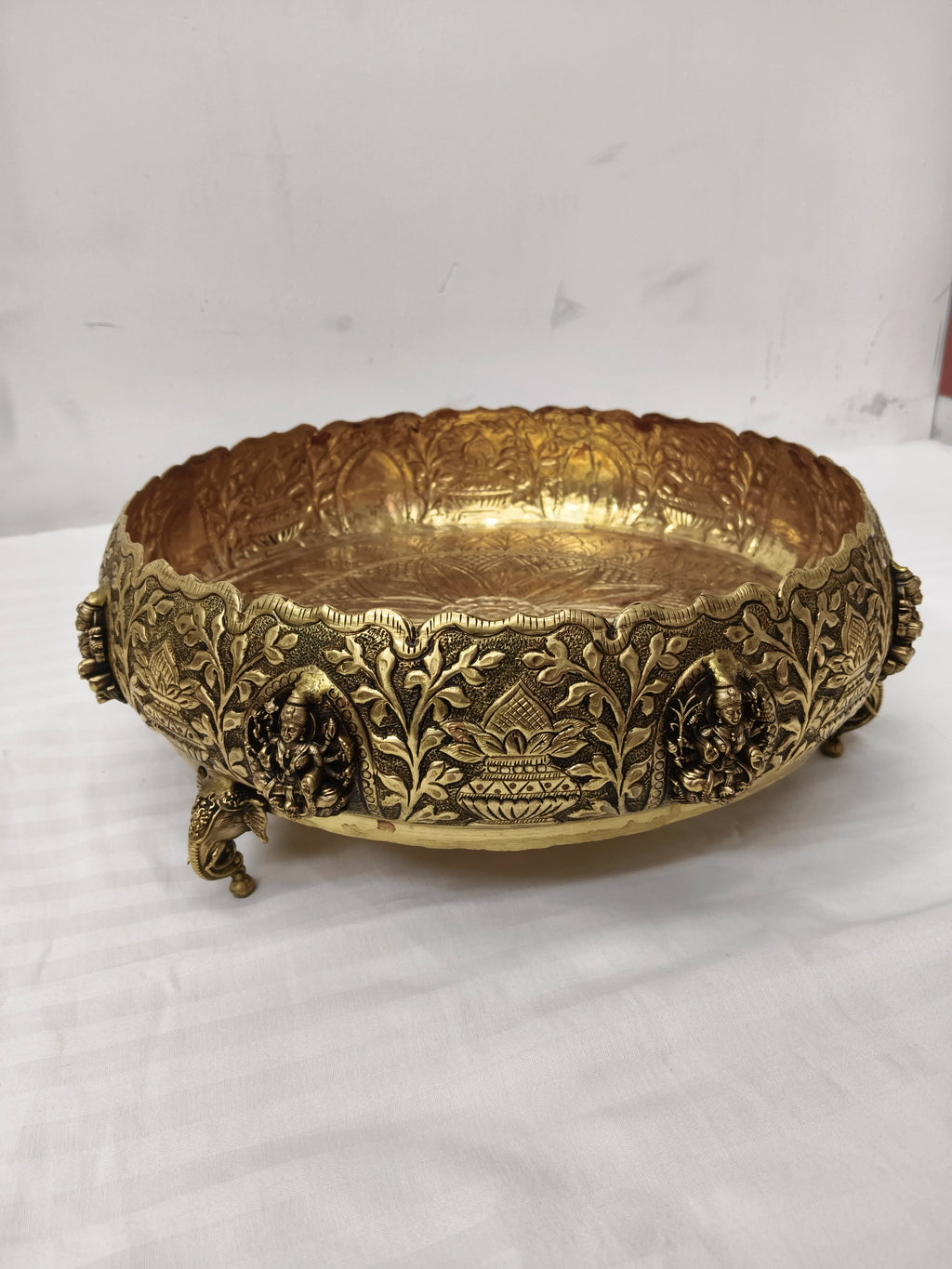 Medium brass Astalakshmi Urli bowl with detailed deity and floral engravings