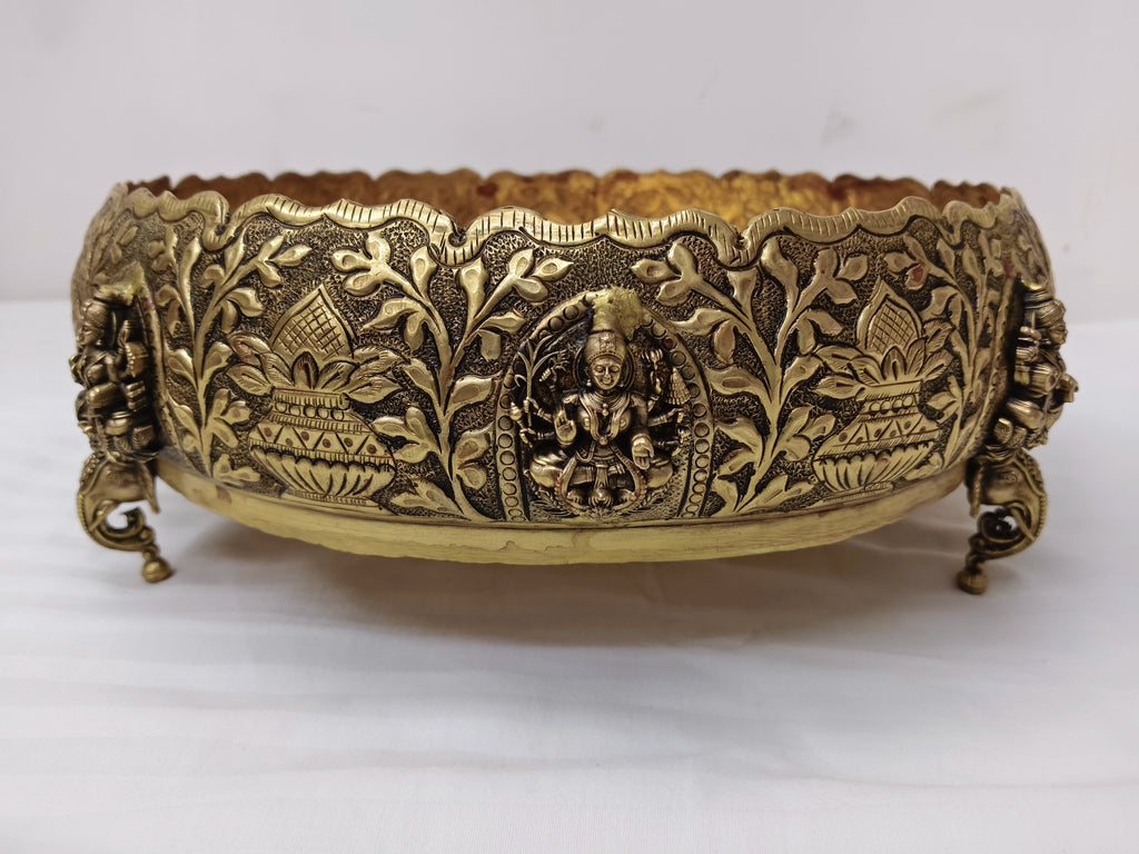 Medium brass Astalakshmi Urli with carved goddess and floral motifs, front view