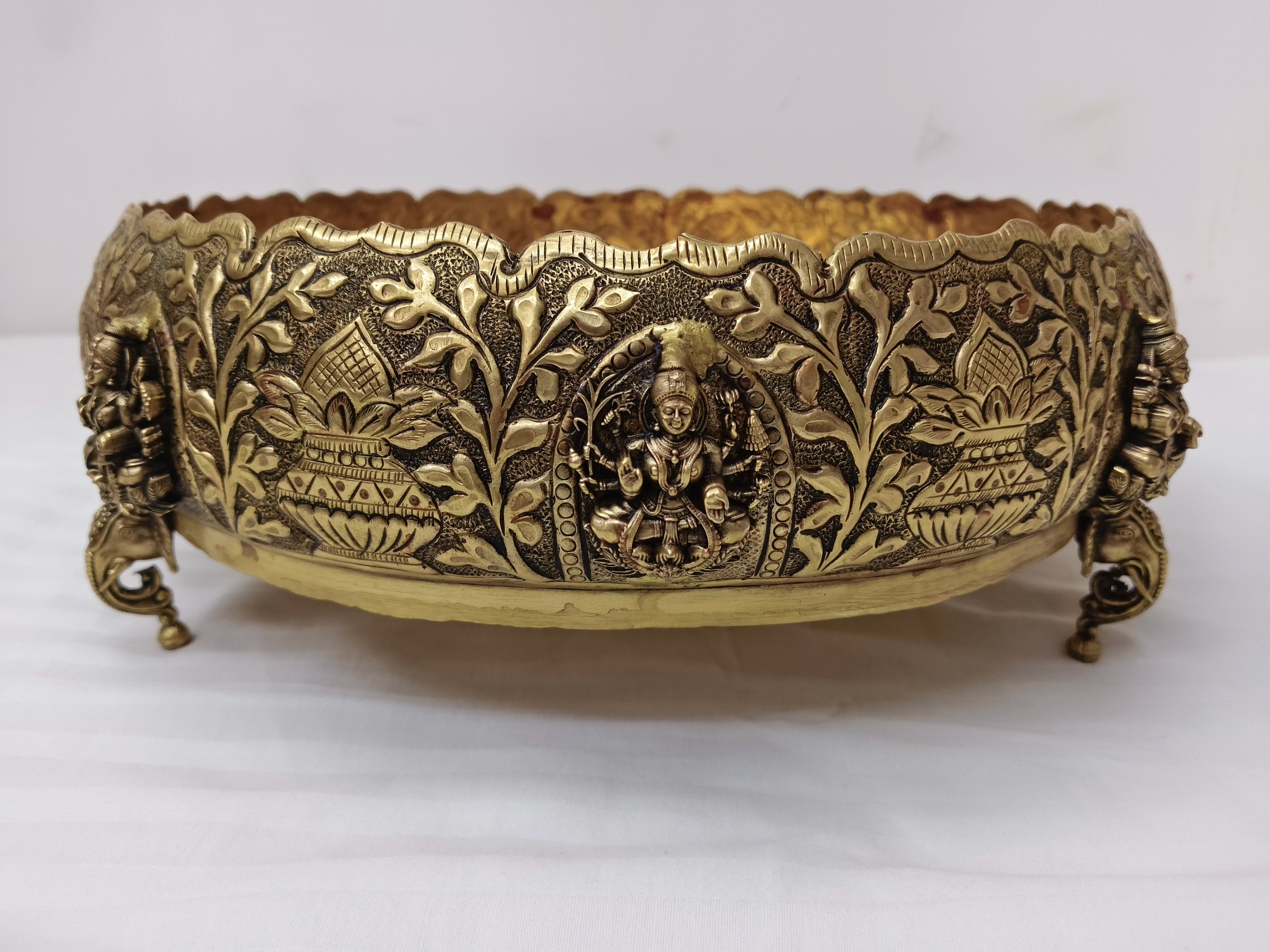 Medium brass Astalakshmi Urli with carved goddess and floral motifs, front view