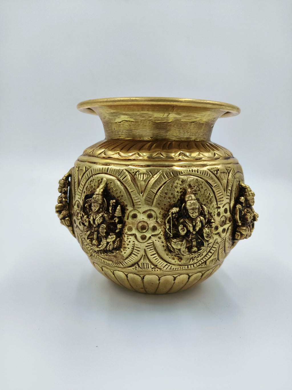 Small brass Ashtalakshmi kalash with engraved deity figures and decorative patterns