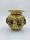 Small brass Ashtalakshmi kalash with engraved deity figures and decorative patterns