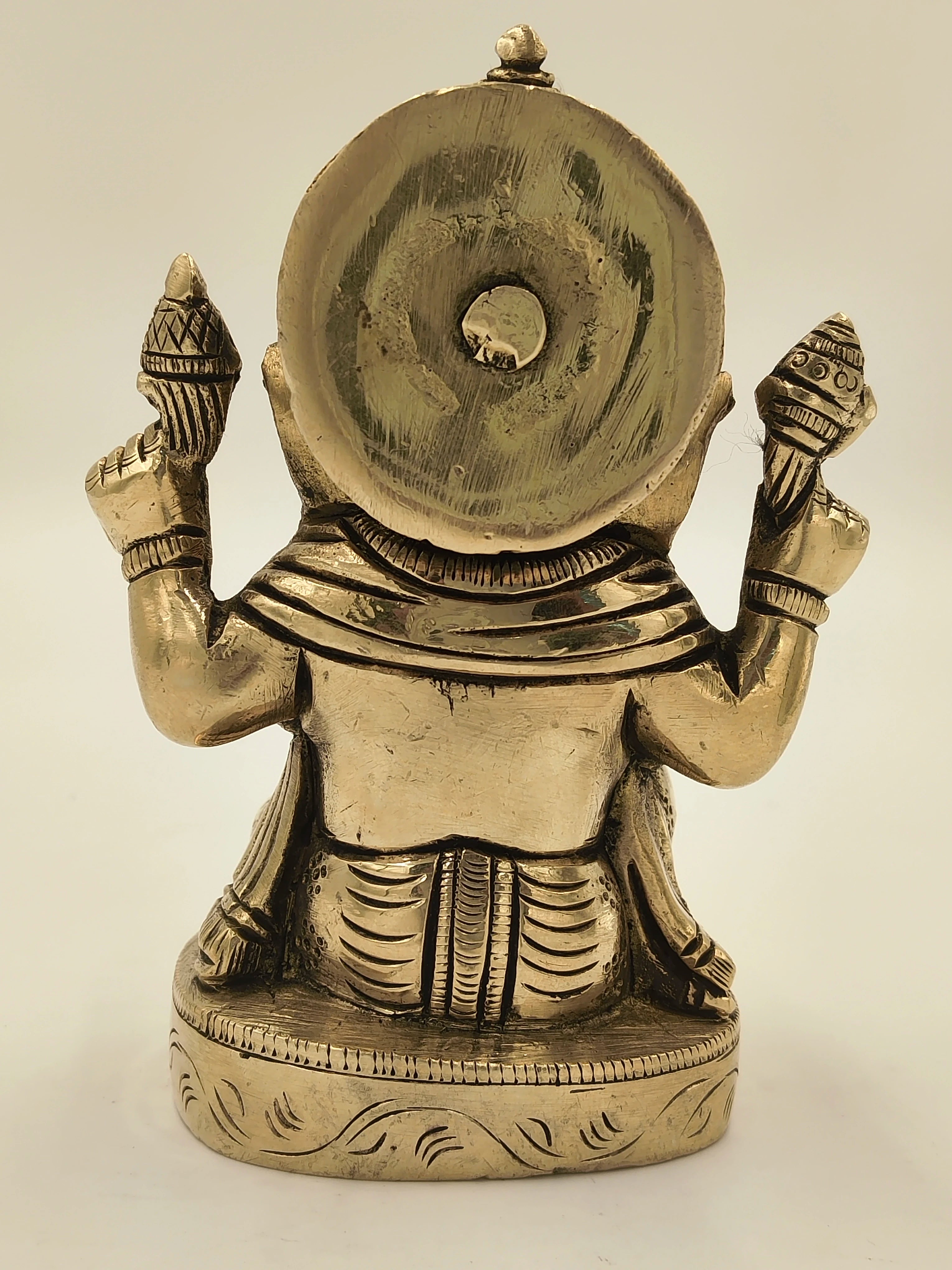 Rear view of brass Ananda Ganapathi statue with intricate detailing