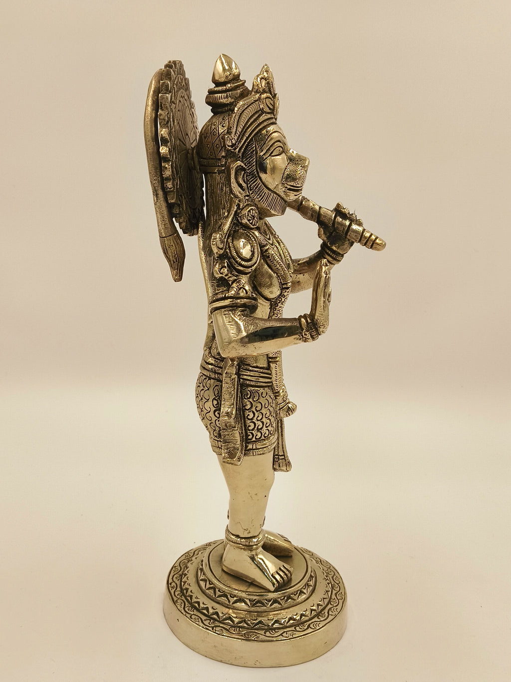 Side view of large brass Rama Dhoota Hanuman figurine on decorated base
