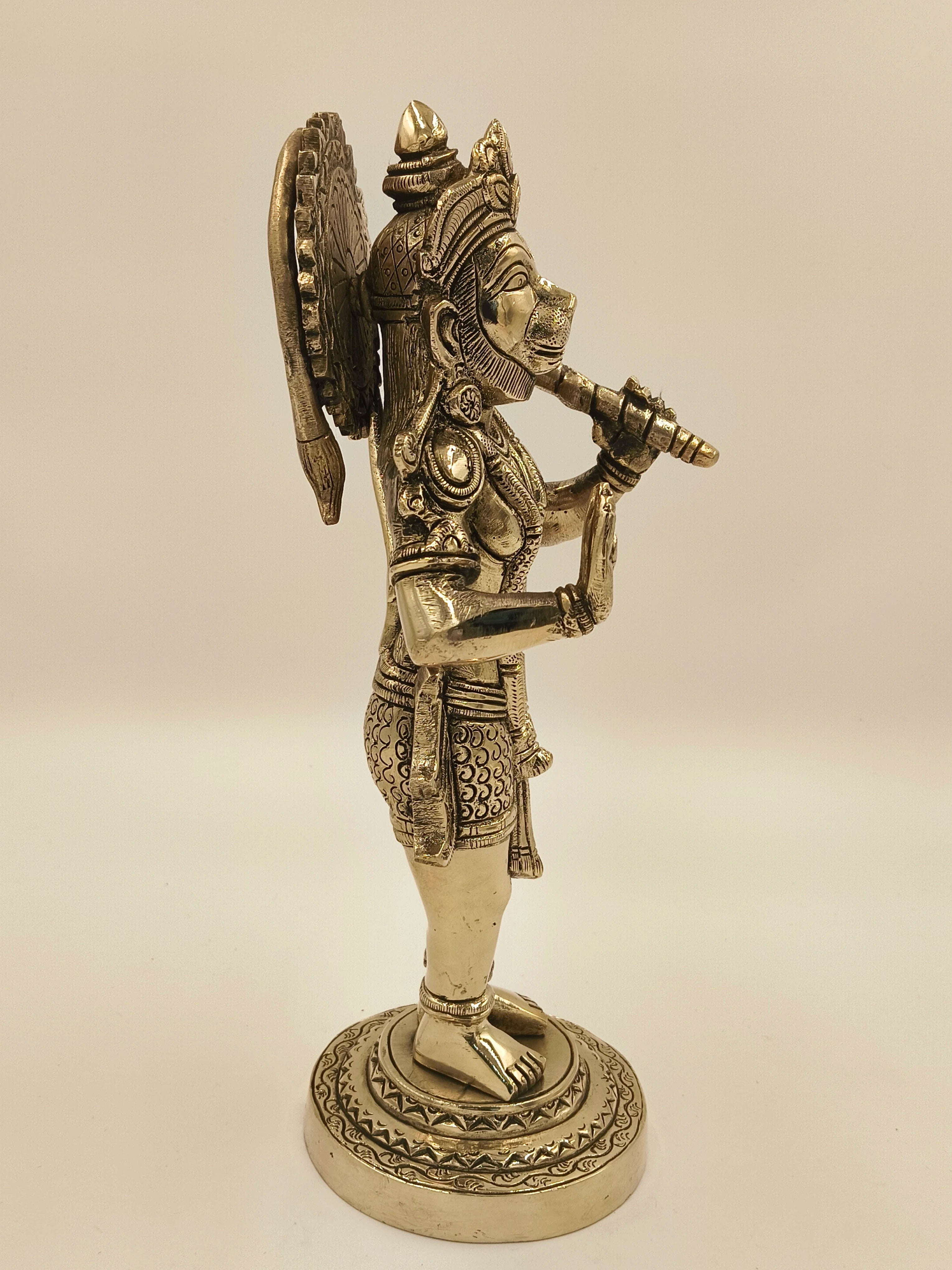 Side view of large brass Rama Dhoota Hanuman figurine on decorated base