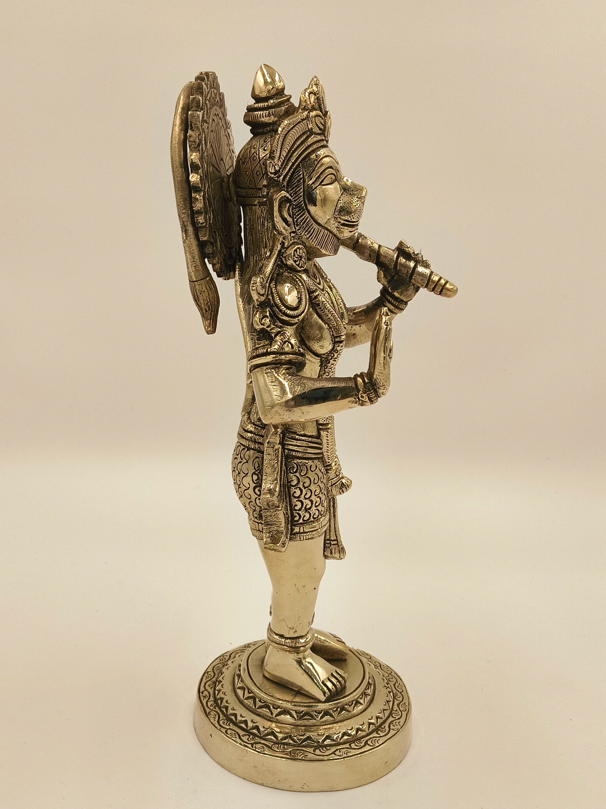 Side view of large brass Rama Dhoota Hanuman figurine on decorated base