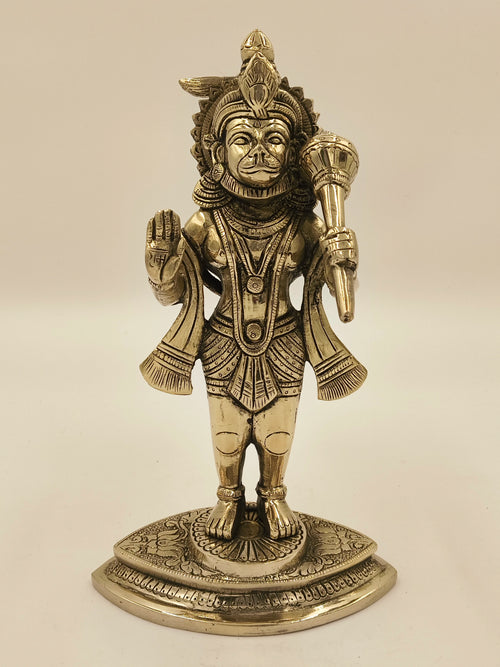 Brass Hanuman sculpture standing on decorated base with raised hand and mace