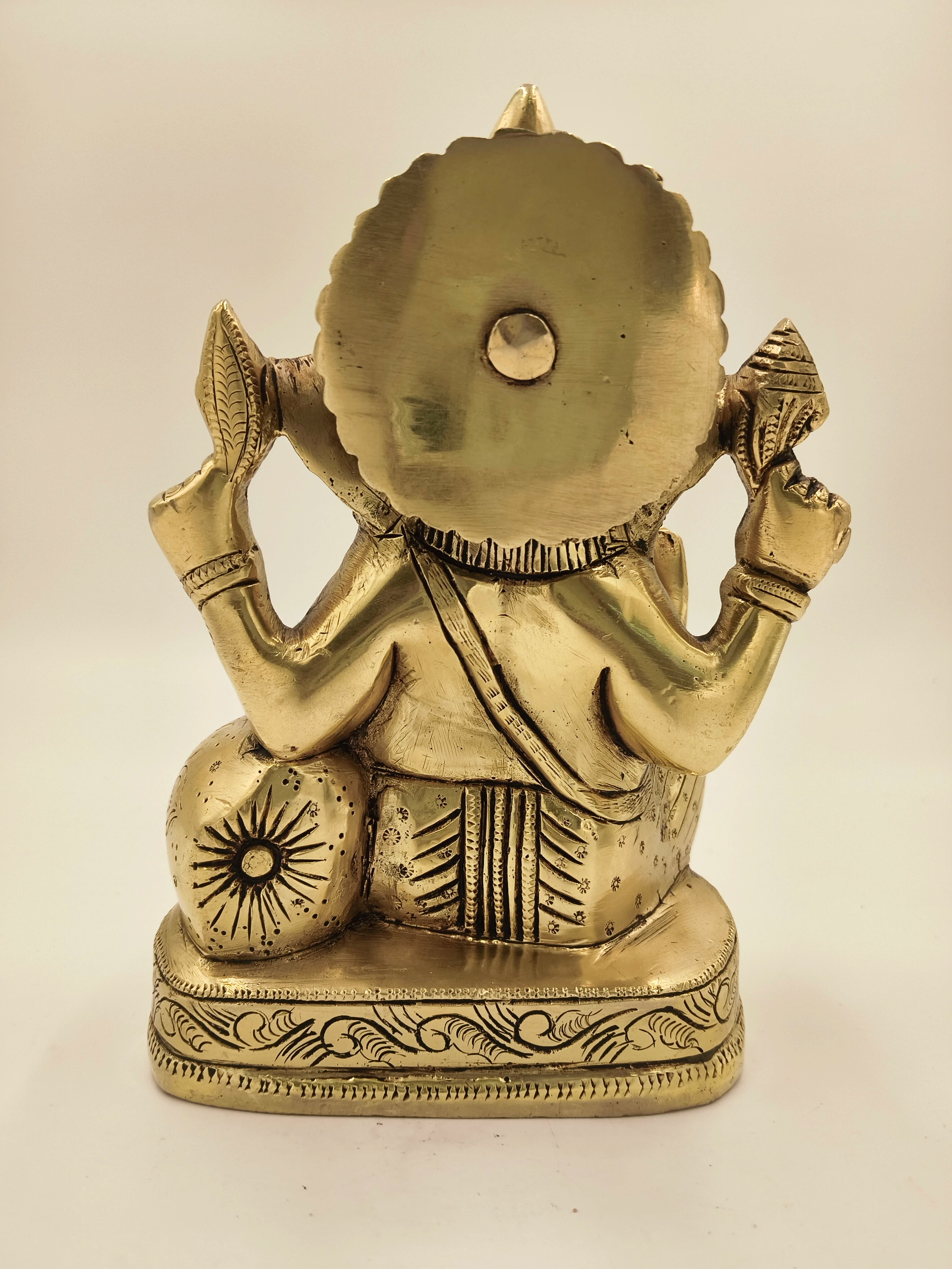 Back view of a large brass Swarna Ganesh statue with detailed engravings