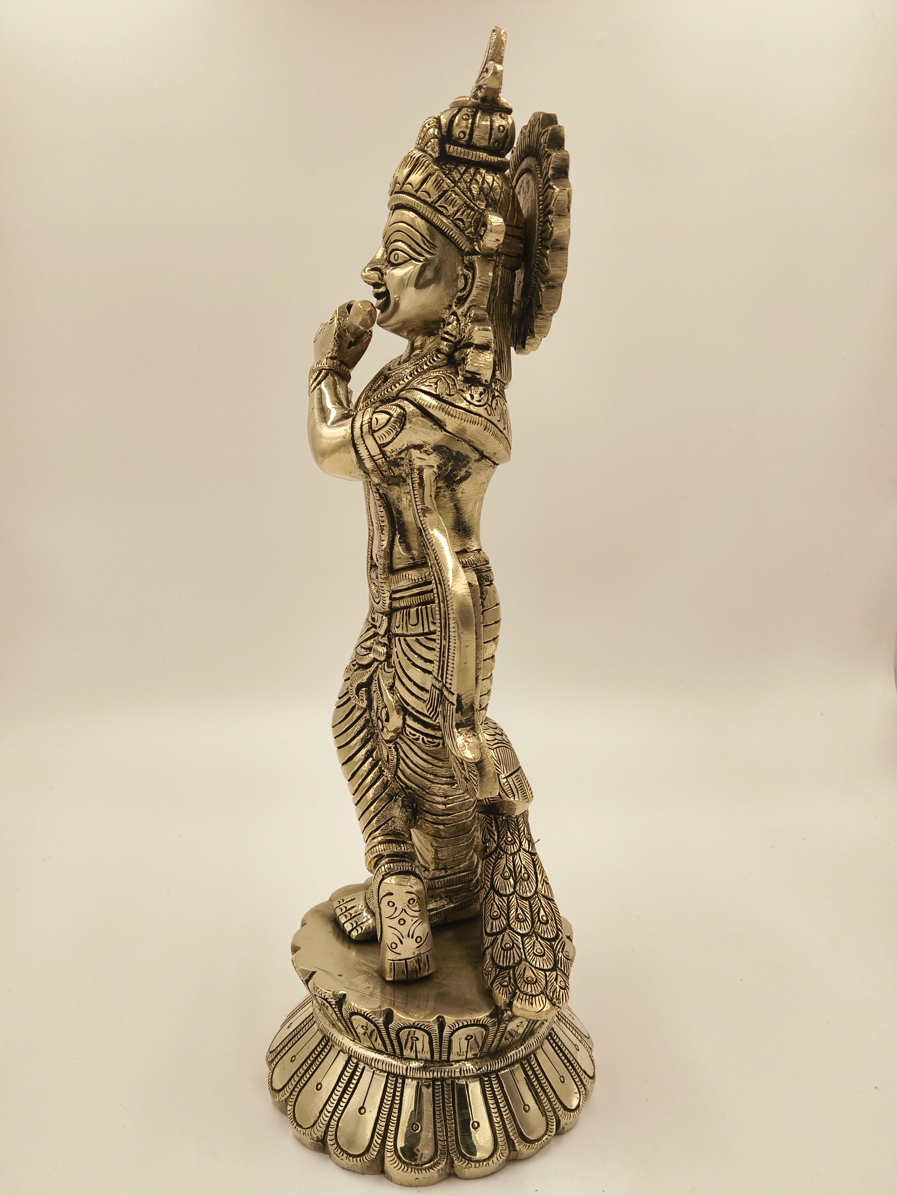 Side view of large brass Govardhan Giridhari statue of Krishna with intricate details