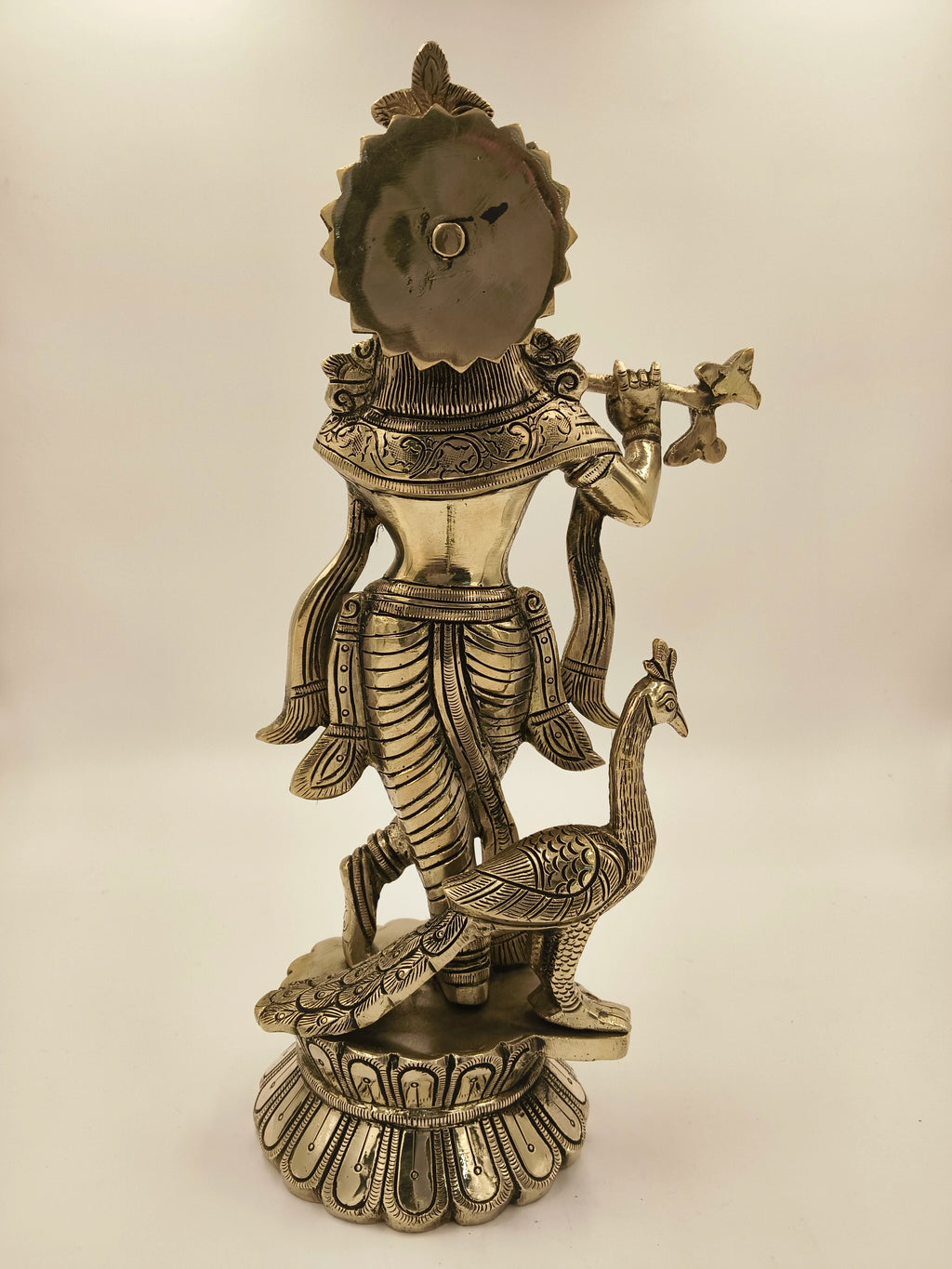 Back view of large brass Govardhan Giridhari Krishna statue with peacock
