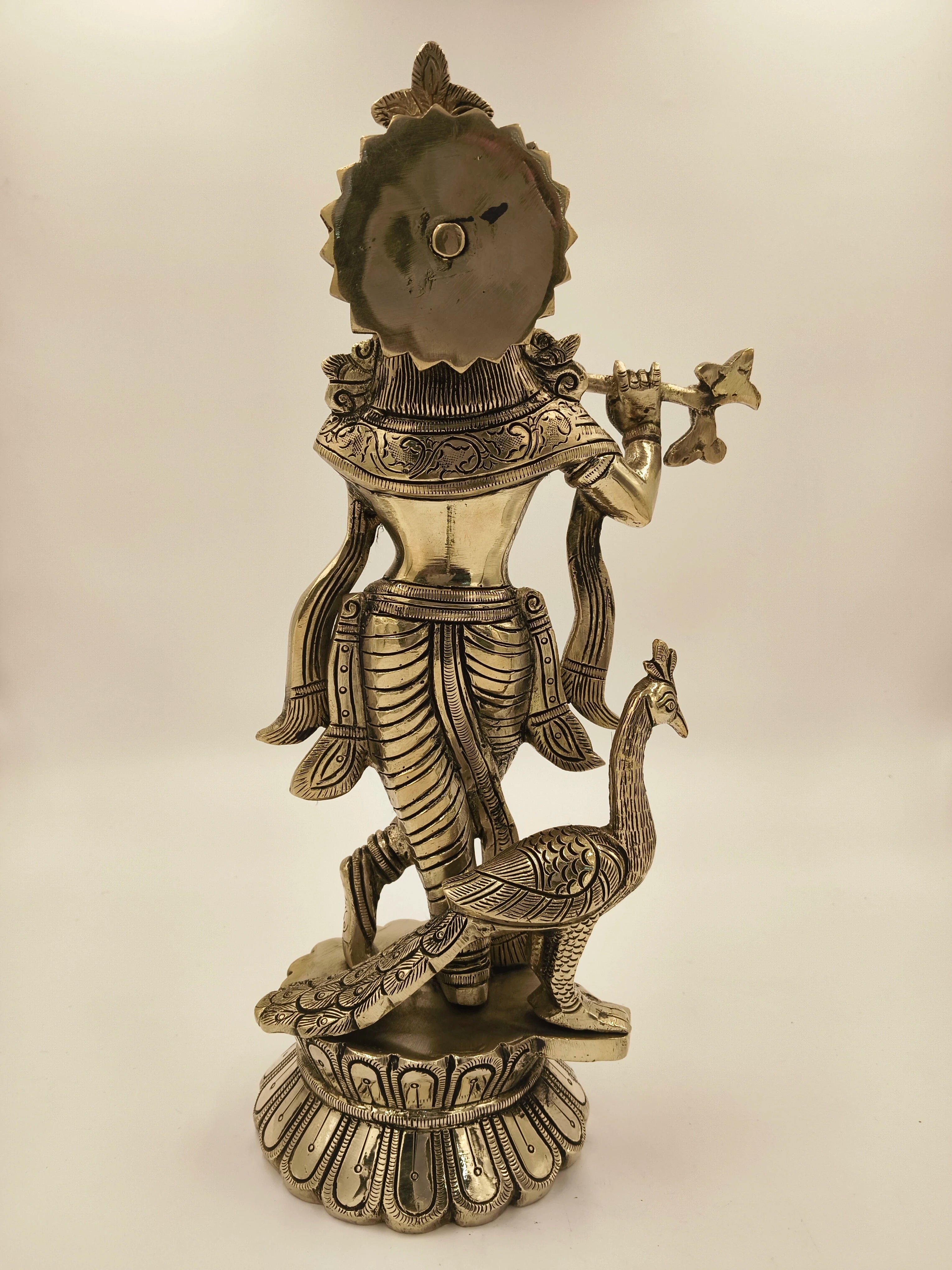 Back view of large brass Govardhan Giridhari Krishna statue with peacock