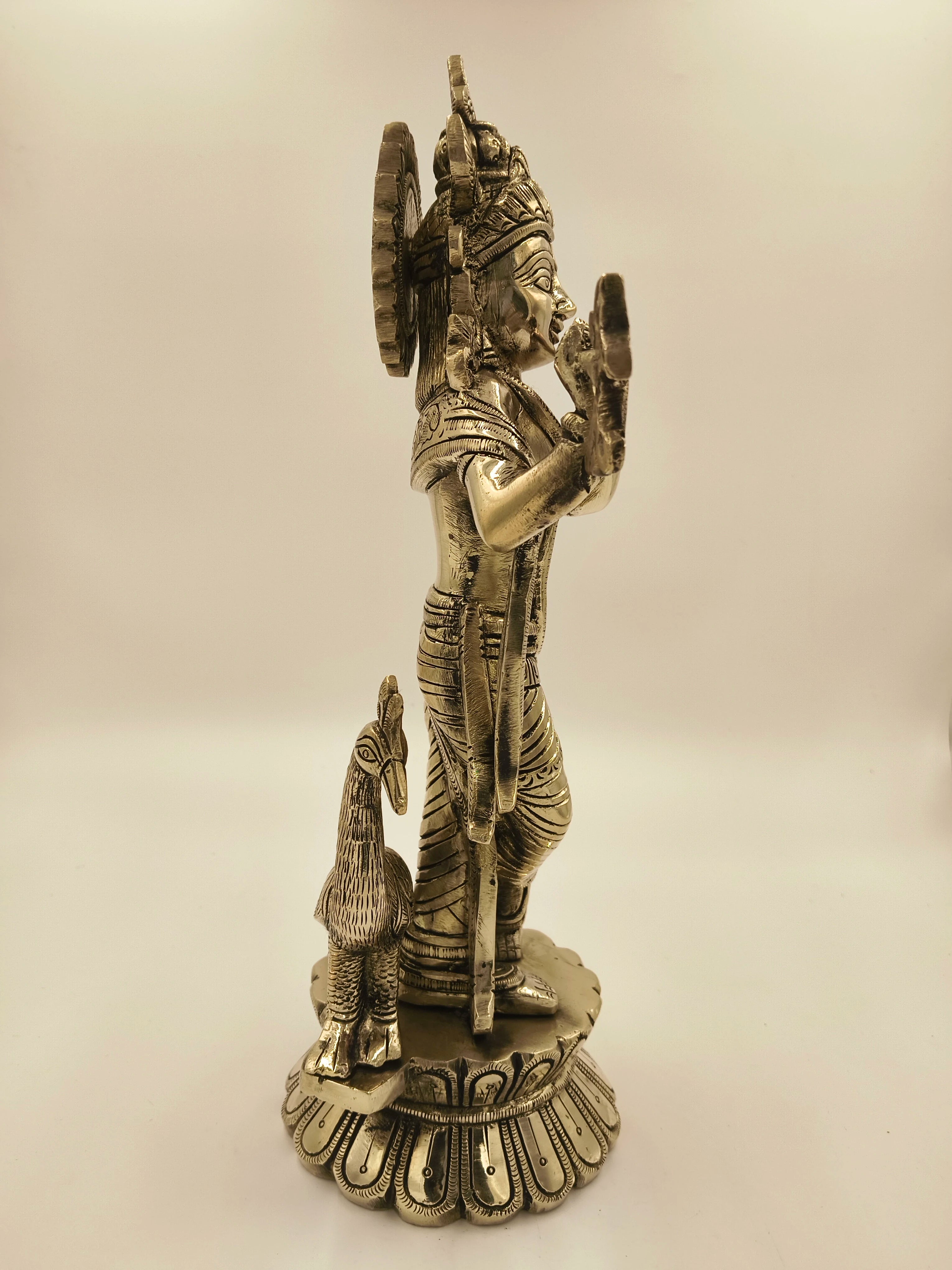 Side view of large brass Govardhan Giridhari Krishna sculpture with peacock