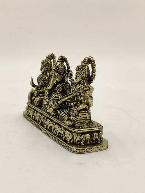 Mini brass sculpture of Lakshmi, Ganesh, and Saraswathi with elephants on base