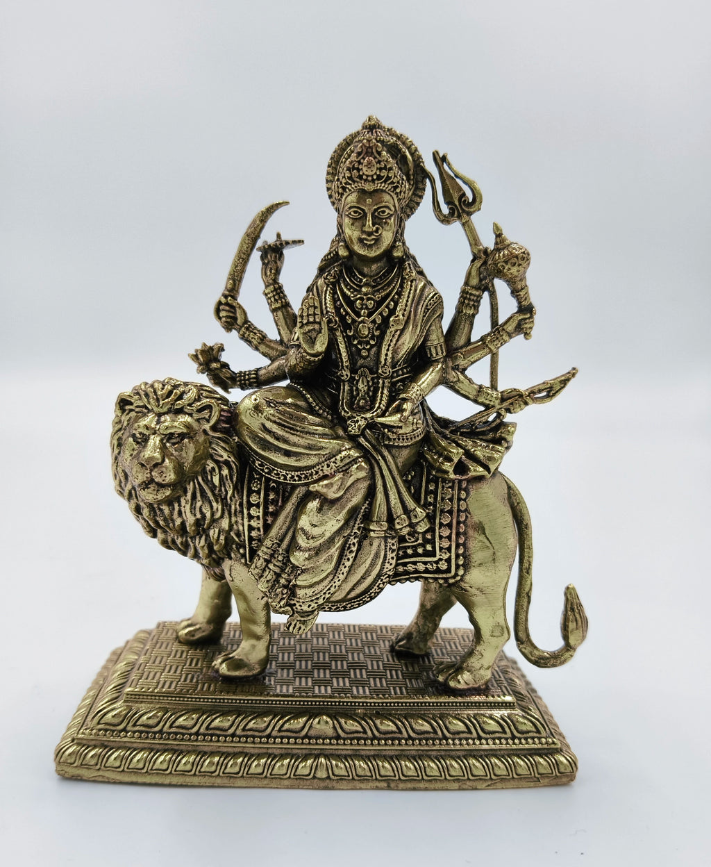 Medium brass sculpture of Goddess Durga seated on a lion with multiple arms