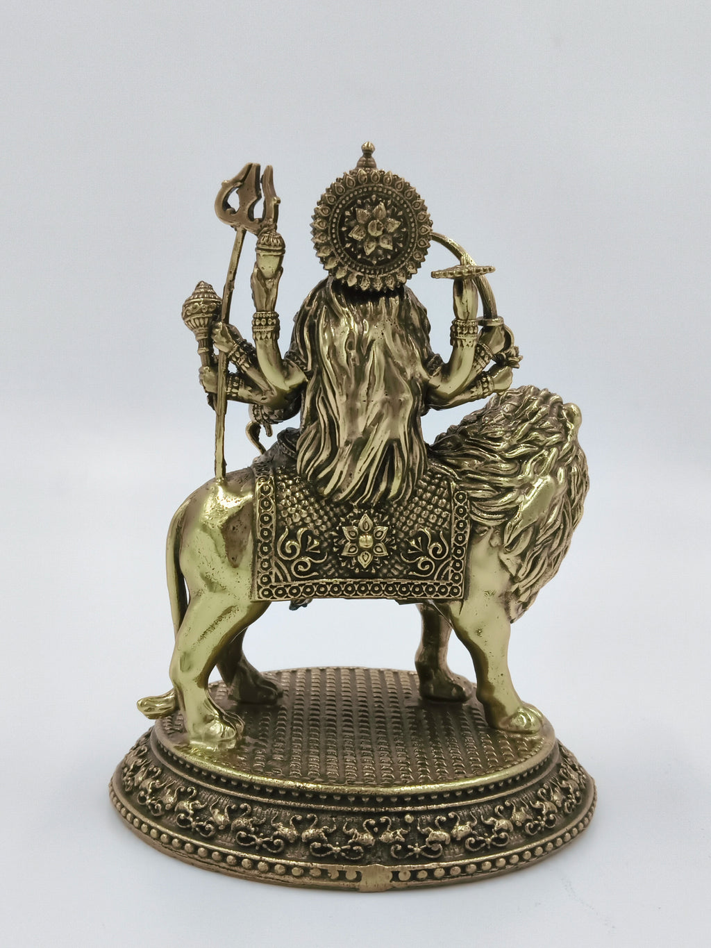 Rear view of medium brass sculpture of Goddess Durga seated on lion