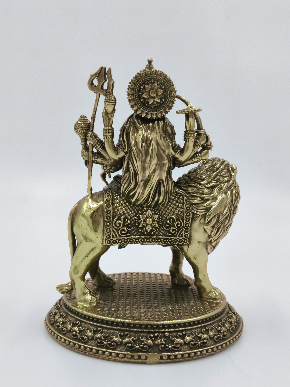 Rear view of medium brass sculpture of Goddess Durga seated on lion