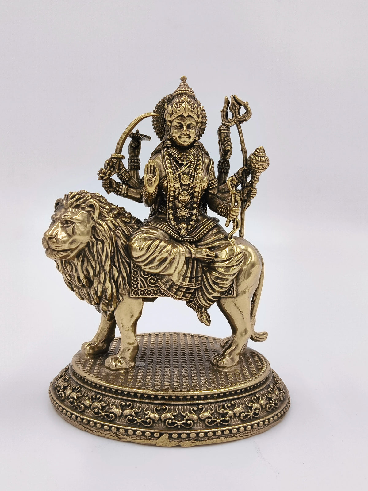 Medium brass statue of Goddess Durga seated on a lion with detailed ornaments