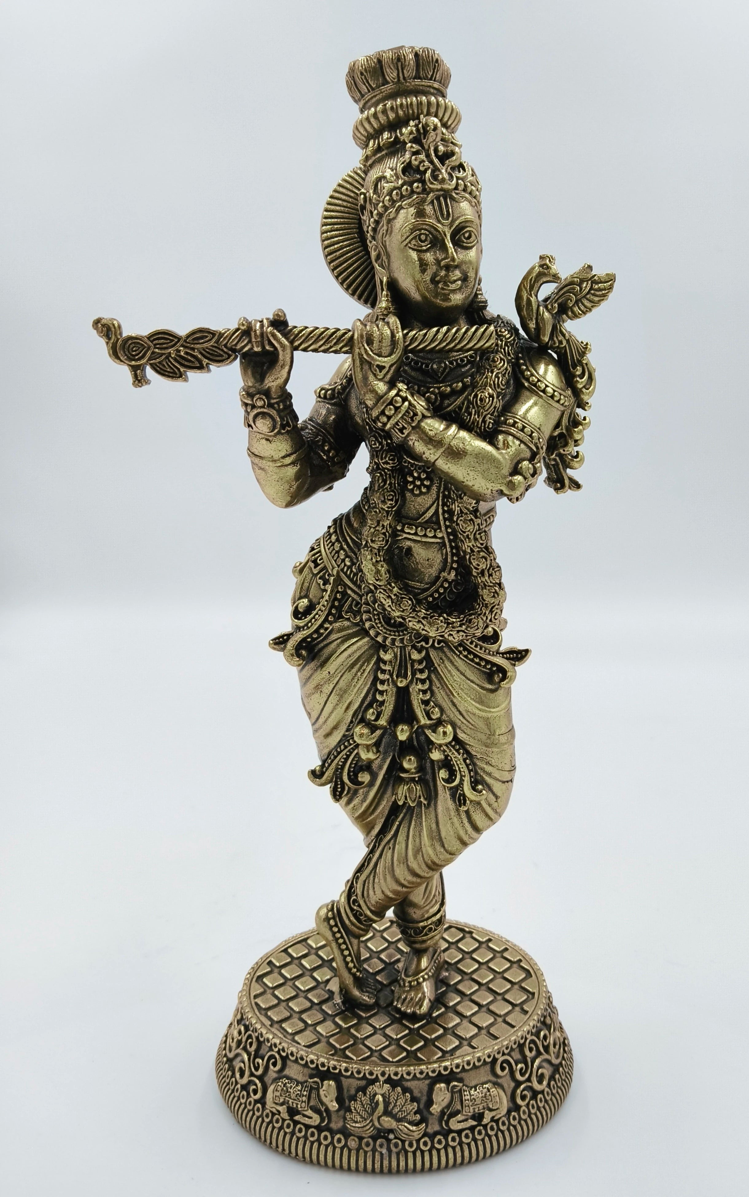 Large brass statue of Krishna playing flute with detailed ornamentation