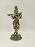 Large brass statue of Lord Krishna playing flute in traditional attire