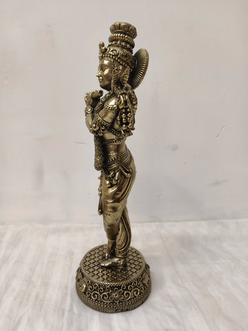 Side view of a large brass Venumadhava Krishna statue on decorative base