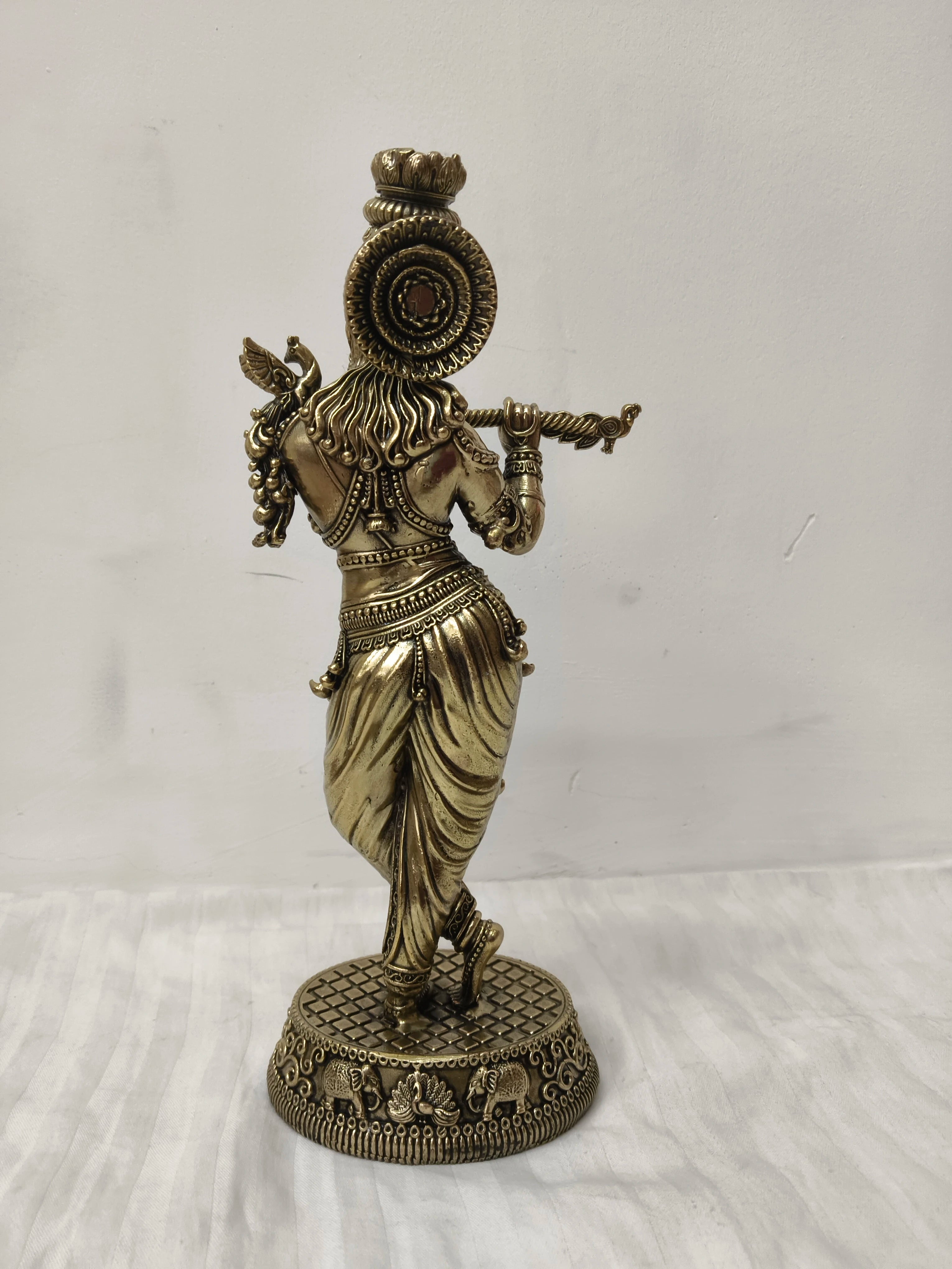 Back view of large brass Venumadhava Krishna statue playing flute